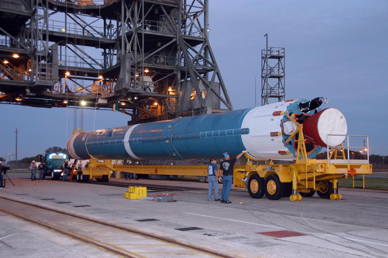 KENNEDY SPACE CENTER, FLA. --   The first stage of a United Launch Alliance Delta II rocket moves into place in front of at the mobile service tower on Launch Pad 17-B at Cape Canaveral Air Force Station in Florida.  The rocket will be raised to a vertical position and lifted into the tower. The rocket is the launch vehicle for the THEMIS spacecraft, consisting of five identical probes, the largest number of scientific satellites ever launched into orbit aboard a single rocket. This unique constellation of satellites will resolve the tantalizing mystery of what causes the spectacular sudden brightening of the aurora borealis and aurora australis - the fiery skies over the Earth's northern and southern polar regions. After the first stage is in the mobile service tower on the pad, nine solid rocket boosters will be placed around the base of the first stage and attached in sets of three.  THEMIS is scheduled to launch aboard the Delta II at 6:07 p.m. EST on Feb. 15.  Photo credit: NASA/George Shelton