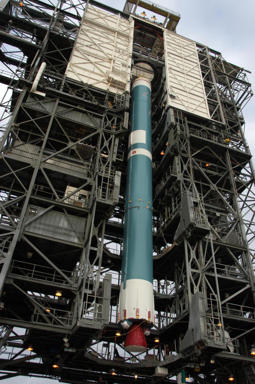 KENNEDY SPACE CENTER, FLA. --  On Launch Pad 17-B at Cape Canaveral Air Force Station in Florida, the United Launch Alliance Delta II rocket is lifted up into the mobile service tower.  The rocket is the launch vehicle for the THEMIS spacecraft, consisting of five identical probes, the largest number of scientific satellites ever launched into orbit aboard a single rocket. This unique constellation of satellites will resolve the tantalizing mystery of what causes the spectacular sudden brightening of the aurora borealis and aurora australis - the fiery skies over the Earth's northern and southern polar regions. After the first stage is in the tower on the pad, nine solid rocket boosters will be placed around the base of the first stage and attached in sets of three.  THEMIS is scheduled to launch aboard the Delta II at 6:07 p.m. EST on Feb. 15.  Photo credit: NASA/George Shelton