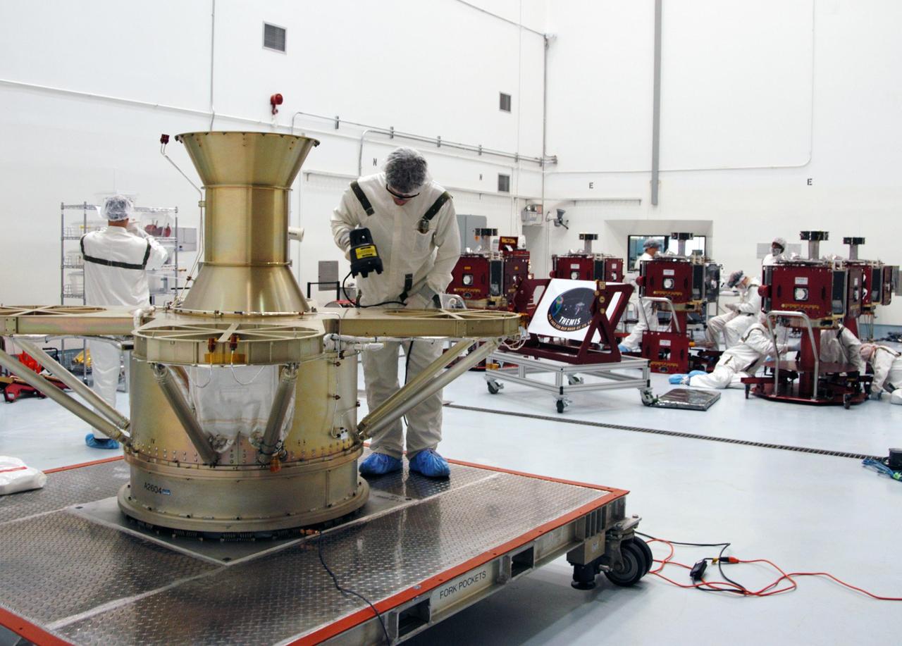 KENNEDY SPACE CENTER, FLA. --  At Astrotech Space Operations, a worker prepares the THEMIS spacecraft for black/white light inspection.  White light inspection assures the telemetry is operating. Black light inspection uses UVA fluorescence to detect possible particulate microcontamination, minute cracks or fluid leaks.  THEMIS consists of five identical probes, the largest number of scientific satellites ever launched into orbit aboard a single rocket. This unique constellation of satellites will resolve the tantalizing mystery of what causes the spectacular sudden brightening of the aurora borealis and aurora australis - the fiery skies over the Earth's northern and southern polar regions. THEMIS is scheduled to launch Feb. 15 from Cape Canaveral Air Force Station.  Photo credit: NASA/George Shelton