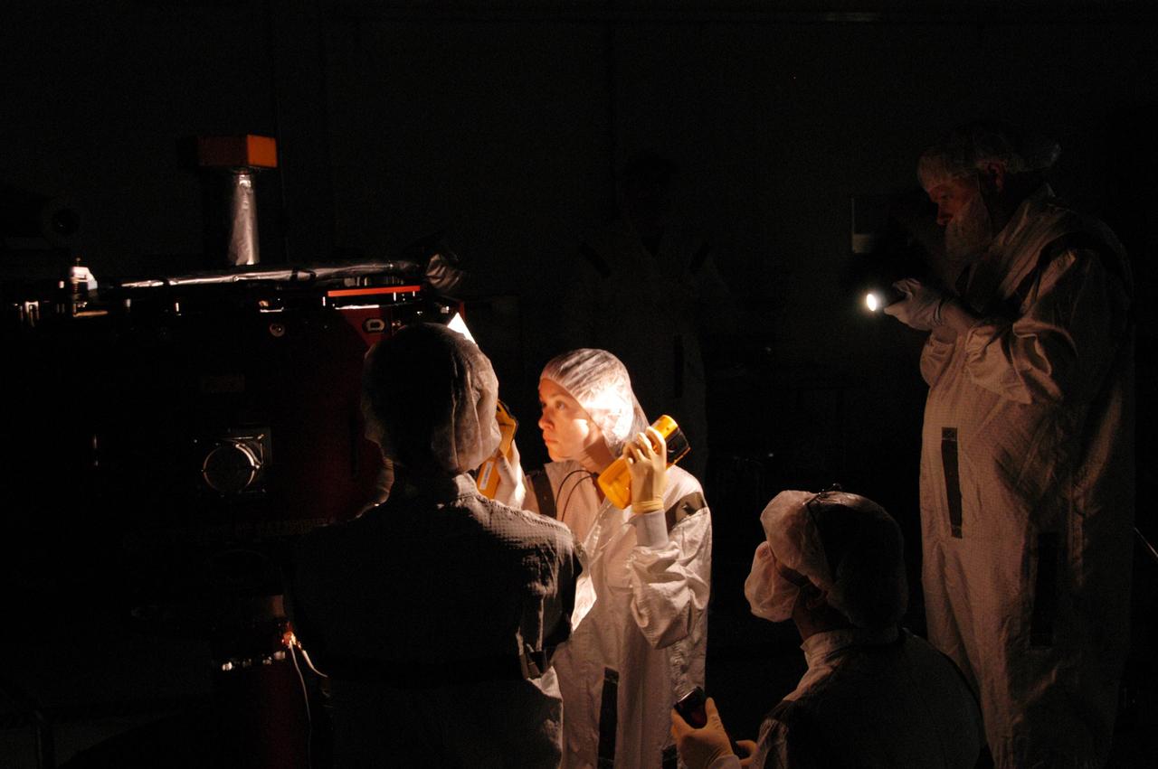 KENNEDY SPACE CENTER, FLA. --  At Astrotech Space Operations, technicians conduct white light inspection of the THEMIS probes.  They will also undergo black light inspection.  White light inspection assures the telemetry is operating. Black light inspection uses UVA fluorescence to detect possible particulate microcontamination, minute cracks or fluid leaks.  THEMIS consists of five identical probes, the largest number of scientific satellites ever launched into orbit aboard a single rocket. This unique constellation of satellites will resolve the tantalizing mystery of what causes the spectacular sudden brightening of the aurora borealis and aurora australis - the fiery skies over the Earth's northern and southern polar regions. THEMIS is scheduled to launch Feb. 15 from Cape Canaveral Air Force Station.  Photo credit: NASA/George Shelton