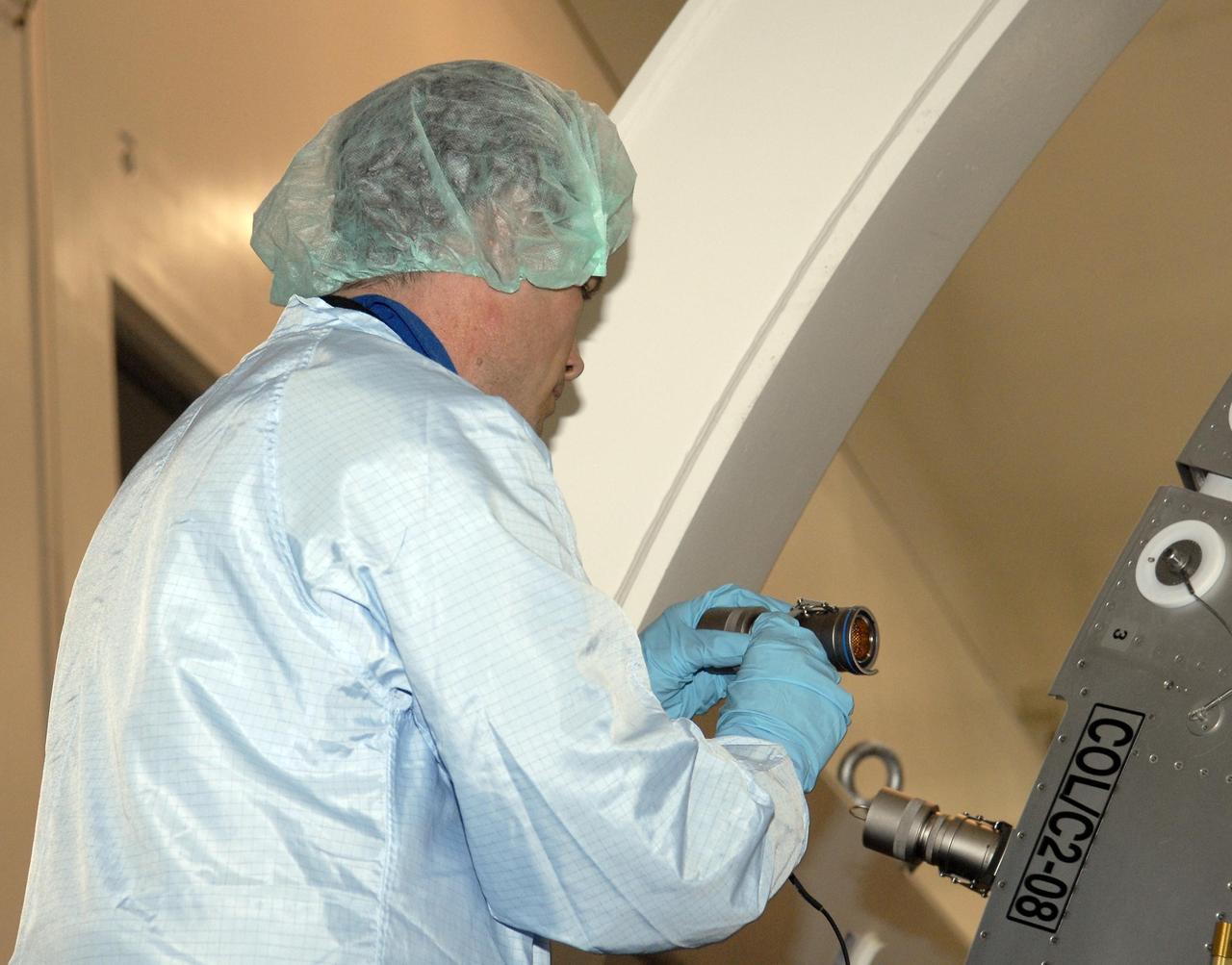 KENNEDY SPACE CENTER, FLA. --   In the Space Station Processing Facility, STS-122 crew members inspect the Columbus European Laboratory, part of the payload on their mission.  Here, Mission Specialist Rex Walheim closely examines a component of the laboratory.  The crew is participating in a crew equipment interface test that provides opportunities for hands-on experience with payloads and equipment.  The other crew members are Commander Steve Frick, Pilot Alan Poindexter and Mission Specialists Stan Love, Leland Melvin and Hans Schlegel, who represents the European Space Agency. The 24th mission to the International Space Station, STS-122 will also include the Multi-Purpose Experiment Support Structure - Non-Deployable (MPESS-ND). Launch of STS-122 on Space Shuttle Discovery is scheduled no earlier than October. Photo credit: NASA/Kim Shiflett