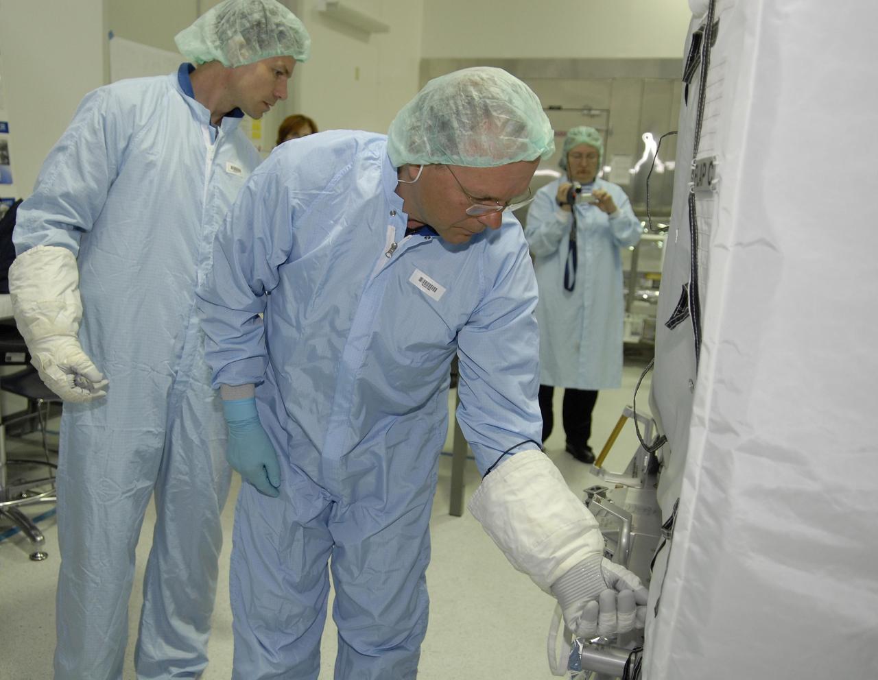 KENNEDY SPACE CENTER, FLA. --  In the Space Station Processing Facility, STS-122 crew members inspect the Multi-Purpose Experiment Support Structure - Non-Deployable (MPESS-ND), part of the payload on their mission.  Here, Mission Specialist Stan Love (left) and Commander Steve Frick get a close look.  The crew is participating in a crew equipment interface test that provides opportunities for hands-on experience with payloads and equipment.  The other crew members are Pilot Alan Poindexter and Mission Specialists Rex Walheim, Leland Melvin and Hans Schlegel, who represents the European Space Agency. The 24th mission to the International Space Station, STS-122 will also include the Columbus European Laboratory.  Launch of STS-122 on Space Shuttle Discovery is scheduled no earlier than October. Photo credit: NASA/Kim Shiflett