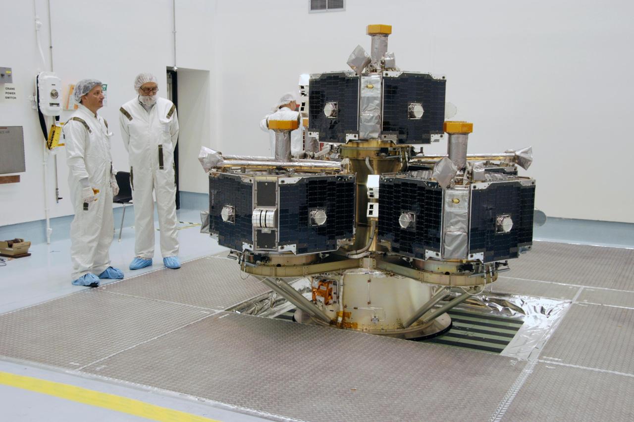 KENNEDY SPACE CENTER, FLA. -- At Astrotech Space Operations, workers look over the integrated THEMIS spacecraft before spin-balance testing. THEMIS consists of five identical probes, the largest number of scientific satellites ever launched into orbit aboard a single rocket. This unique constellation of satellites will resolve the tantalizing mystery of what causes the spectacular sudden brightening of the aurora borealis and aurora australis - the fiery skies over the Earth's northern and southern polar regions. THEMIS is scheduled to launch Feb. 15 from Cape Canaveral Air Force Station. Photo credit: NASA/George Shelton