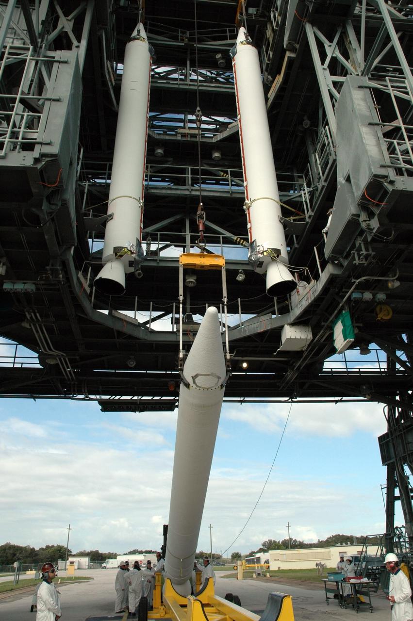 KENNEDY SPACE CENTER, FLA. -- Another solid rocket booster is raised to a vertical position for lifting into the mobile service tower on Launch Pad 17-B at Cape Canaveral Air Force Station. The boosters are being installed around the United Launch Alliance Delta II rocket for launch of the THEMIS integrated spacecraft. THEMIS consists of five identical probes, the largest number of scientific satellites ever launched into orbit aboard a single rocket. This unique constellation of satellites will resolve the tantalizing mystery of what causes the spectacular sudden brightening of the aurora borealis and aurora australis - the fiery skies over the Earth's northern and southern polar regions. THEMIS is scheduled to launch Feb. 15 from Cape Canaveral Air Force Station. Photo credit: NASA/Jack Pfaller
