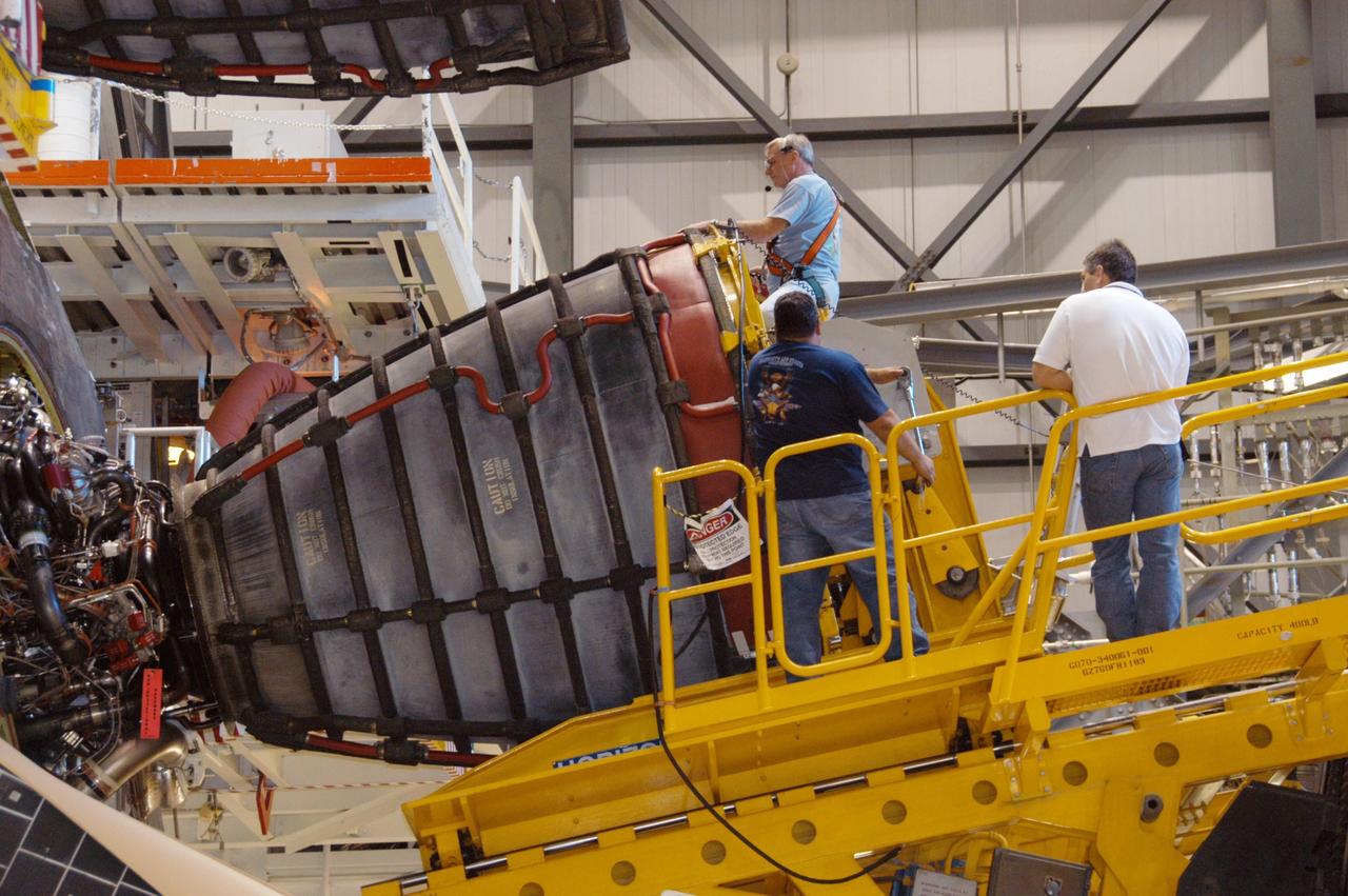 KENNEDY SPACE CENTER, FLA. --   In Orbiter Processing Facility bay 2, technicians on a Hyster forklift maneuver space shuttle main engine no. 3 into place on Endeavour.  Each space shuttle main engine is 14 feet long, weighs about 6,700 pounds, and is 7.5 feet in diameter at the end of the nozzle. The orbiter is scheduled for mission STS-118, targeted for launch on June 28.  The mission will be the 22nd flight to the International Space Station, carrying another starboard array, S5, for installation.  Photo credit: NASA/George Shelton