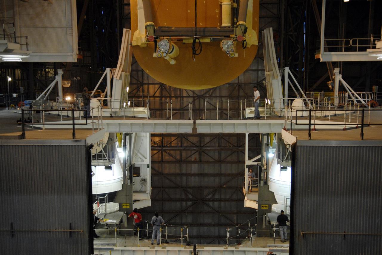 KENNEDY SPACE CENTER, FLA. --  External tank No. 124 is lowered into high bay 1 of the Vehicle Assembly Building where it will be mated with the solid rocket boosters for mission STS-117.  The boosters are already in place on the mobile launcher platform in the VAB.  The mission is targeted to launch on March 16 aboard Space Shuttle Atlantis.  Photo credit: NASA/Kim Shiflett