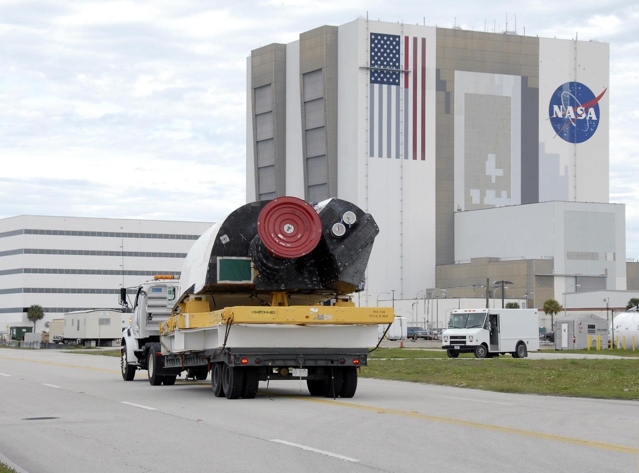 KENNEDY SPACE CENTER, FLA. -- The right-hand orbital maneuvering system pod is driven past the Vehicle Assembly Building on its way to Orbiter Processing Facility bay 2 for installation on the orbiter Endeavour. The orbital maneuvering system/reaction control system left- and right-hand pods are attached to the upper aft fuselage left and right sides. Each pod is fabricated primarily of graphite epoxy composite and aluminum. Each pod is 21.8 feet long and 11.37 feet wide at its aft end and 8.41 feet wide at its forward end, with a surface area of approximately 435 square feet. The orbiter is being prepared for its first launch in just over four years. The vehicle has undergone an extensive modification period, including the addition of all of the return-to-flight safety upgrades added to both Discovery and Atlantis. Endeavour is targeted for launch of mission STS-118 on June 28. Photo credit: NASA/Kim Shiflett