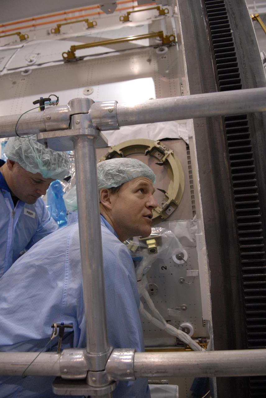 KENNEDY SPACE CENTER, FLA. -- In the Space Station Processing Facility at NASA's Kennedy Space Center, STS-120 Mission Specialist Scott Parazynski checks out the primary payload for the mission: the U.S. Node 2, another element to be added to the International Space Station. Parazynski and other crew members are familiarizing themselves with the payload. Node 2 will provide a passageway between three station science experiment facilities: the U.S. Destiny Laboratory, the Kibo Japanese Experiment Module, and the European Columbus Laboratory. STS-120 is targeted for launch on Sept. 7 with a crew of six, including Commander Pam Melroy, Pilot George Zamka, and Mission Specialist Mike Foreman. Photo credit: NASA/Kim Shiflett