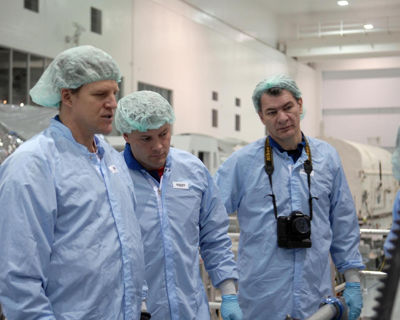 KENNEDY SPACE CENTER, FLA. --  STS-120 Mission Specialists Scott Parazynski (left), Doug Wheelock (center) and Paolo Nespoli (right) check out the primary payload for the mission: the U.S. Node 2, another element to be added to the International Space Station. Nespoli represents the European Space Agency.  Node 2 will provide a passageway between three station science experiment facilities: the U.S. Destiny Laboratory, the Kibo Japanese Experiment Module, and the European Columbus Laboratory. STS-120 is targeted for launch on Sept. 7 with a crew of six, including Commander Pam Melroy, Pilot George Zamka, and Mission Specialist Mike Foreman.  Photo credit: NASA/Kim Shiflett