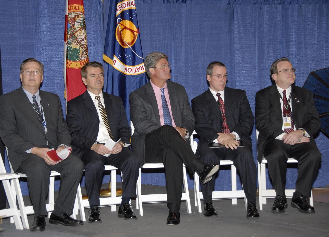 KENNEDY SPACE CENTER, FLA. -- Representatives from NASA, Lockheed Martin, Space Florida and the state of Florida are seated on stage at a ceremony to commemorate the transition of the historic Operations and Checkout (O&C) Building high bay for use by the Constellation Program. From left are Cleon Lacefield, Lockheed Martin program manager; Thad Altman, representative of the State of Florida; Bill Parsons, Kennedy Space Center director; Steve Koller, executive director of Space Florida; and Skip Hatfield, Orion Project manager. Representatives from NASA, Lockheed Martin, Space Florida and the state of Florida are seated on stage at a ceremony to commemorate the transition of the historic Operations and Checkout (O&C) Building high bay for use by the Constellation Program. From left are Cleon Lacefield, Lockheed Martin program manager; Thad Altman, representative of the State of Florida; Bill Parsons, Kennedy Space Center director; Steve Koller, executive director of Space Florida; and Skip Hatfield, Orion Project manager. Originally built to process space vehicles in the Apollo era, the O&C Building will serve as the final assembly facility for the Orion crew exploration vehicle. Orion, America's human spaceflight vehicle of the future, will be capable of transporting four crewmembers for lunar missions and later will support crew transfers for Mars missions. Each Orion spacecraft also may be used to support up to six crewmembers to the International Space Station after the space shuttle is retired in 2010. Design, development and construction of Orion's components will be performed by Lockheed Martin for NASA at facilities throughout the country. Photo credit: NASA/Kim Shiflett