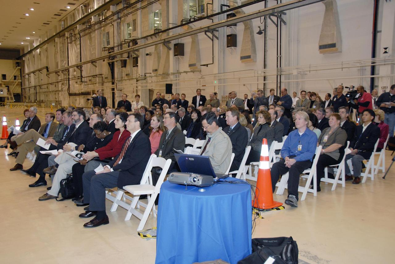 KENNEDY SPACE CENTER, FLA. -- Employees and guests are seated in the Operations and Checkout (O&C) Building high bay for the ceremony commemorating the bay's transition for use by the Constellation Program.  Originally built to process space vehicles in the Apollo era, the O&C Building will serve as the final assembly facility for the Orion crew exploration vehicle. Orion, America's human spaceflight vehicle of the future, will be capable of transporting four crewmembers for lunar missions and later will support crew transfers for Mars missions. Each Orion spacecraft also may be used to support up to six crewmembers to the International Space Station after the space shuttle is retired in 2010.  Design, development and construction of Orion's components will be performed by Lockheed Martin for NASA at facilities throughout the country.  Photo credit: NASA/Kim Shiflett
