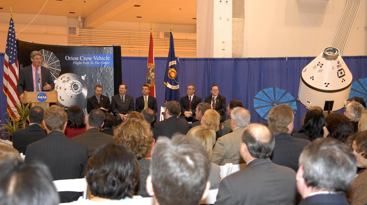 KENNEDY SPACE CENTER, FLA. -- Kennedy Space Center Director Bill Parsons addresses guests and attendees in the Operations and Checkout (O&C) Building high bay in the ceremony commemorating the bay's transition for use by the Constellation Program. Representatives from NASA, Lockheed Martin, Space Florida and the state of Florida are seated at right: Russell Romanella, director of the International Space Station/Payload Processing Directorate at Kennedy Space Center, Cleon Lacefield, Lockheed Martin program manager; Thad Altman, representative of the State of Florida; Steve Koller, executive director of Space Florida; and Skip Hatfield, Orion Project manager. Originally built to process space vehicles in the Apollo era, the O&C Building will serve as the final assembly facility for the Orion crew exploration vehicle. Orion, America's human spaceflight vehicle of the future, will be capable of transporting four crewmembers for lunar missions and later will support crew transfers for Mars missions. Each Orion spacecraft also may be used to support up to six crewmembers to the International Space Station after the space shuttle is retired in 2010. Design, development and construction of Orion's components will be performed by Lockheed Martin for NASA at facilities throughout the country. Photo credit: NASA/Kim Shiflett