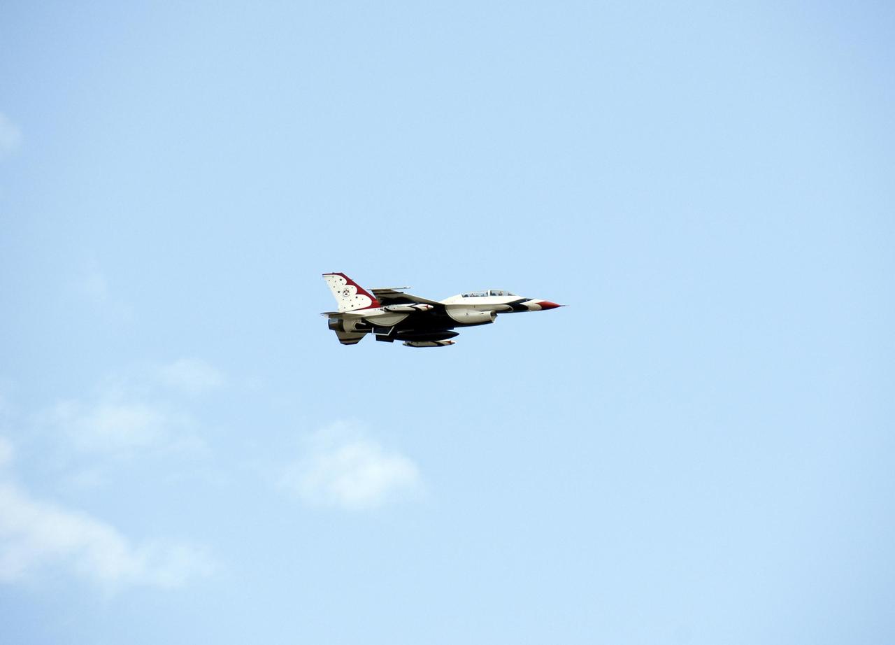 KENNEDY SPACE CENTER, FLA. --  A U.S. Air Force Thunderbird F-16D aircraft streaks through the sky over NASA's Kennedy Space Center.  The pilot is Major Tad Clark, who, after landing at the Shuttle Landing Facility, announced that Kennedy Space Center Visitor Complex will host the inaugural World Space Expo from Nov. 3 to 11. The Expo, which will feature an aerial salute by the Thunderbirds on its opening weekend, will create one of the largest displays of space artifacts, hardware and personalities ever assembled in one location with the objective to inspire, educate and engage the public by highlighting the achievements and benefits of space exploration.  Photo credit: NASA/Kim Shiflett