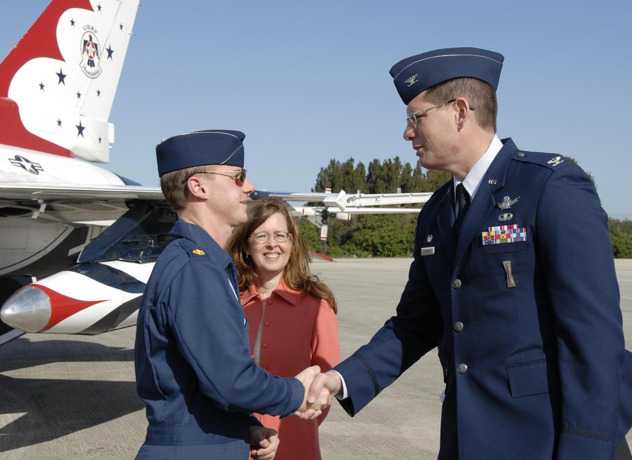 KENNEDY SPACE CENTER, FLA. --  The U.S. Air Force Thunderbird F-16D pilot Maj. Tad Clark is greeted by Col. Dave Thompson with the U.S. Air Force 45th Space Wing.  Between them is Lisa Malone, director of External Relations at KSC.  Clark flew in to KSC to announce to waiting media that the Visitor Complex will host the inaugural World Space Expo from Nov. 3 to 11. The Expo, which will feature an aerial salute by the Thunderbirds on its opening weekend, will create one of the largest displays of space artifacts, hardware and personalities ever assembled in one location with the objective to inspire, educate and engage the public by highlighting the achievements and benefits of space exploration.  Photo credit: NASA/Kim Shiflett