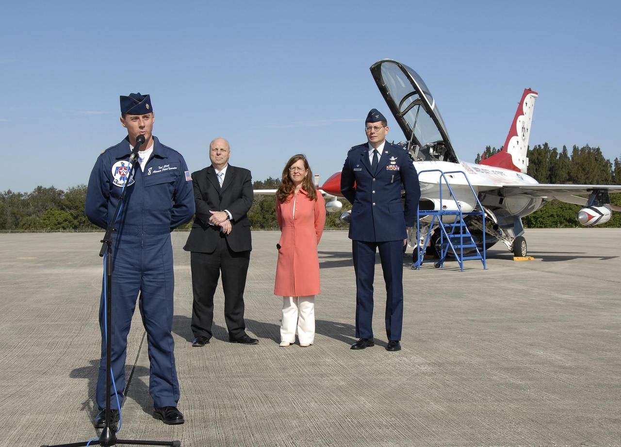 KENNEDY SPACE CENTER, FLA. --   Maj. Tad Clark, pilot of the U.S. Air Force Thunderbird F-16D (background), announces to waiting media that the KSC Visitor Complex will host the inaugural World Space Expo from Nov. 3 to 11. Behind Clark are (from left) Dan LeBlanc, chief operating officer of the KSC Visitor Complex, Lisa Malone, director of External Relations at KSC, and Col. Dave Thompson with the U.S. Air Force 45th Space Wing.  The Expo, which will feature an aerial salute by the Thunderbirds on its opening weekend, will create one of the largest displays of space artifacts, hardware and personalities ever assembled in one location with the objective to inspire, educate and engage the public by highlighting the achievements and benefits of space exploration.  Photo credit: NASA/Kim Shiflett