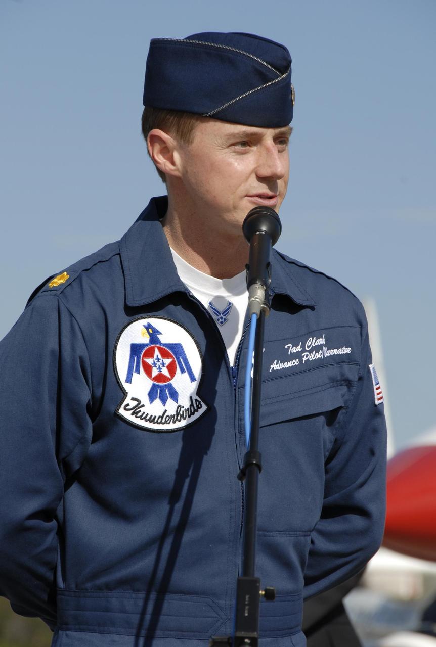 KENNEDY SPACE CENTER, FLA. --   Maj. Tad Clark, pilot of the U.S. Air Force Thunderbird F-16D (background), announces to waiting media that the KSC Visitor Complex will host the inaugural World Space Expo from Nov. 3 to 11.  The Expo, which will feature an aerial salute by the Thunderbirds on its opening weekend, will create one of the largest displays of space artifacts, hardware and personalities ever assembled in one location with the objective to inspire, educate and engage the public by highlighting the achievements and benefits of space exploration.  Photo credit: NASA/Kim Shiflett