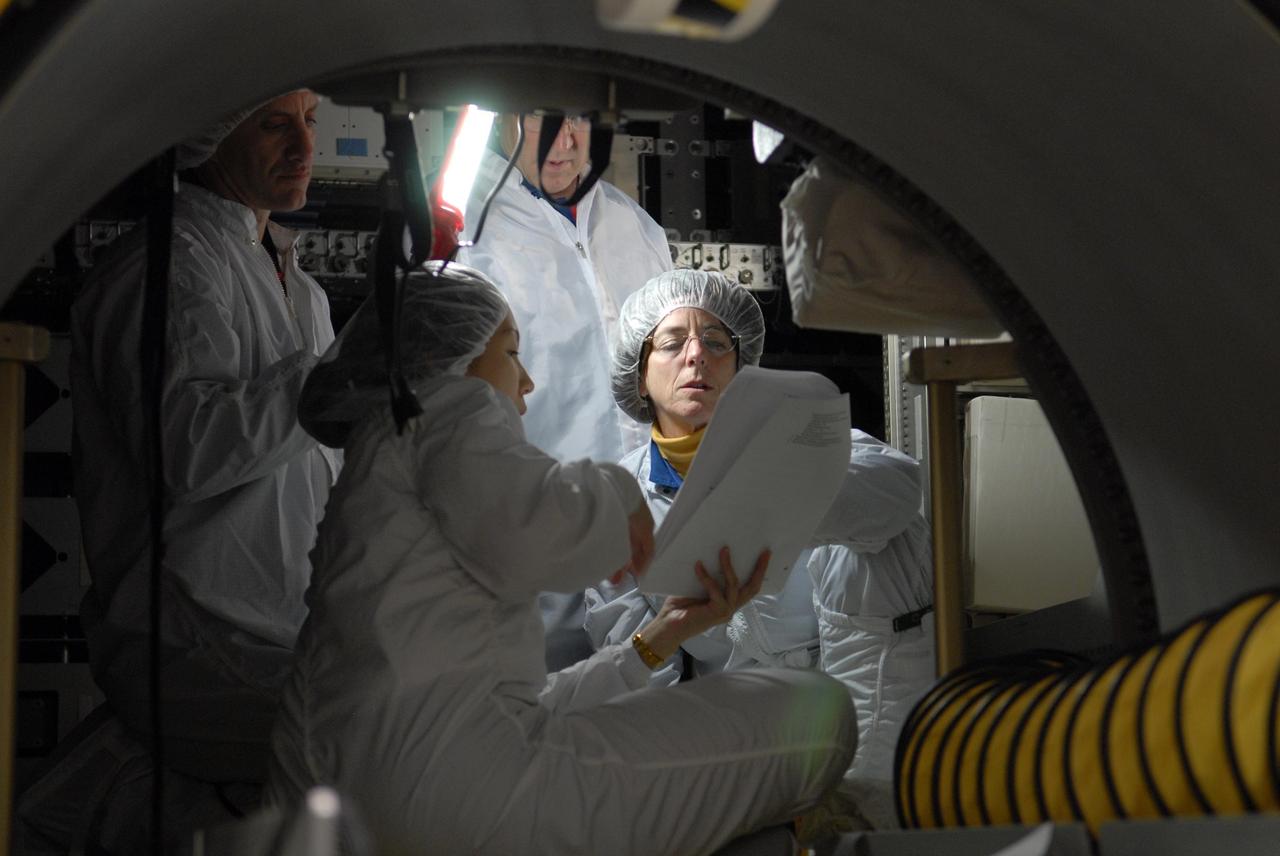 KENNEDY SPACE CENTER, FLA. -- Members of the STS-118 crew take part in a hardware review of the SPACEHAB module, part of the payload on their mission. Seen here inside the module are Mission Specialists Richard Mastracchio (left), Dafydd Williams (center, standing) and Barbara Morgan (lower right). Williams represents the Canadian Space Agency. The mission payload also includes the third starboard truss segment (ITS S5), a control moment gyro and the external stowage platform 3 (ESP3). STS-118 is targeted to launch June 28 from Launch Pad 39A. Photo credit: NASA/Kim Shiflett