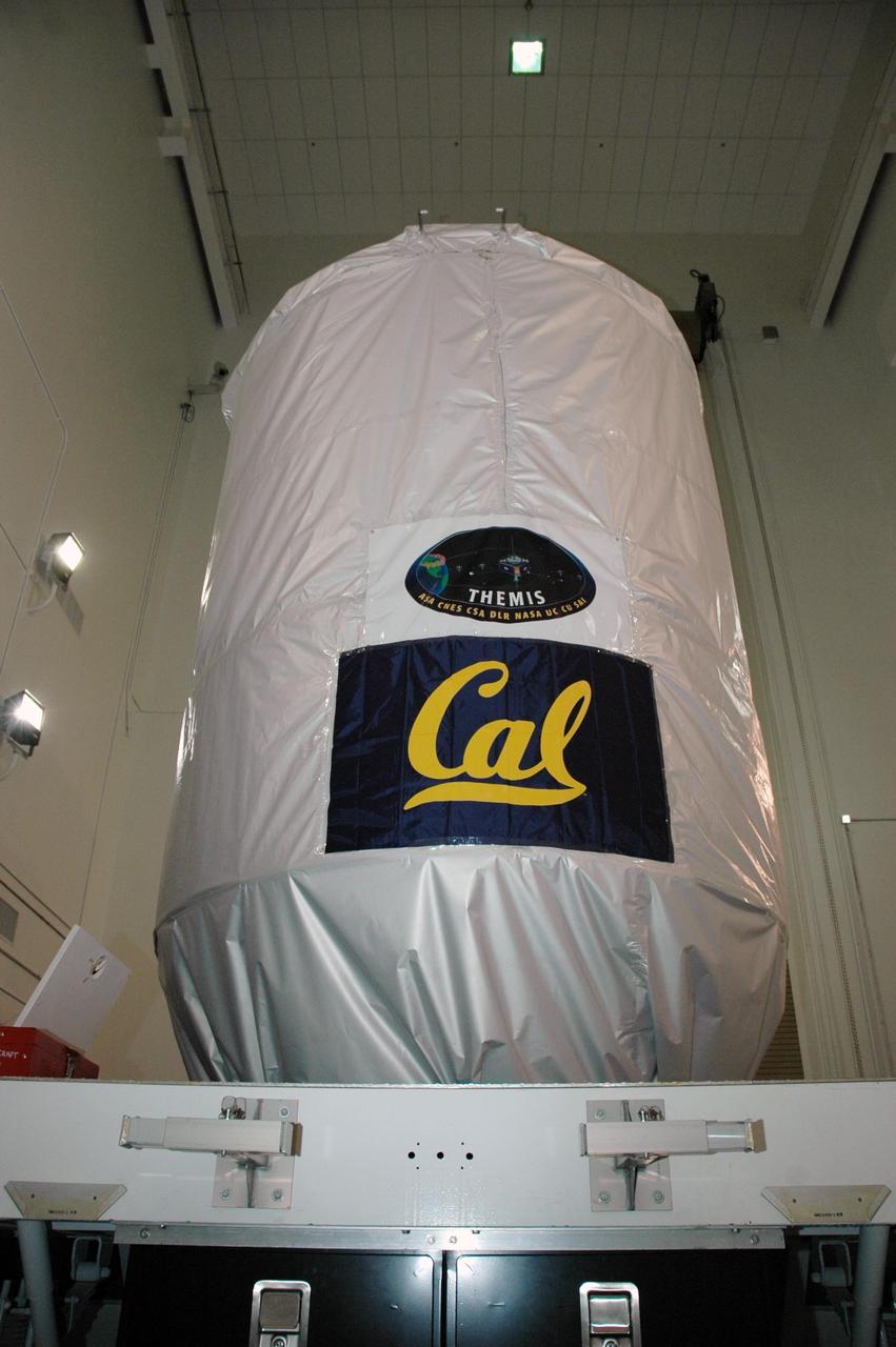 KENNEDY SPACE CENTER, FLA. --  At Astrotech Space Operations in Titusville, Fla., the THEMIS spacecraft is secure inside a protective cover for its transfer to Launch Complex 17 on Cape Canaveral Air Force Station.  On Launch Pad 17-B, the spacecraft will be mated with the third stage of the Delta II rocket.  THEMIS consists of five identical probes, the largest number of scientific satellites ever launched into orbit aboard a single rocket. The THEMIS mission is to investigate what causes auroras in the Earth's atmosphere to dramatically change from slowly shimmering waves of light to wildly shifting streaks of color. Discovering what causes auroras to change will provide scientists with important details on how the planet's magnetosphere works and the important Sun-Earth connection.  THEMIS is scheduled to launch aboard a Delta II rocket on Feb. 15 during a window extending from 6:08 to 6:27 p.m.  Photo credit: NASA/Amanda Diller