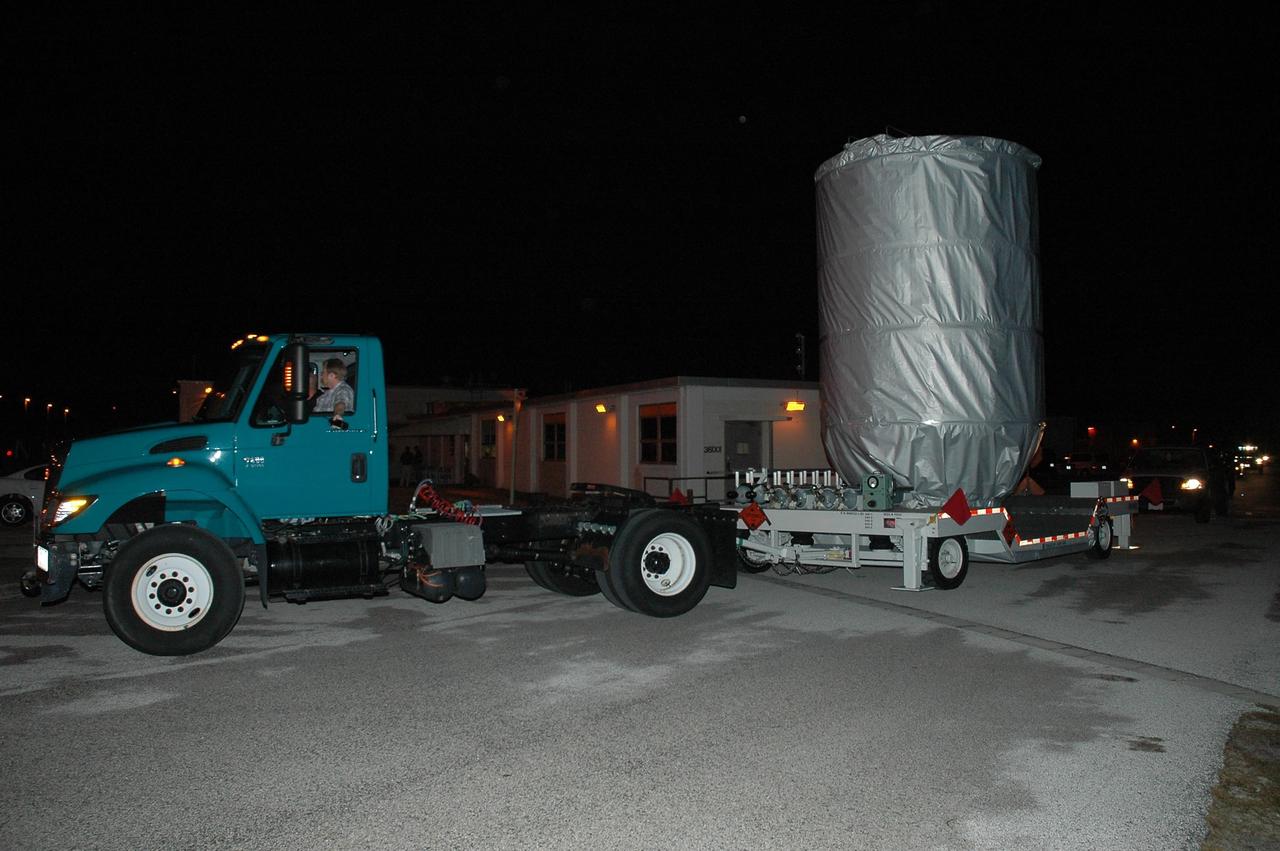 KENNEDY SPACE CENTER, FLA. --   The covered THEMIS spacecraft is transported to Launch Complex 17 on Cape Canaveral Air Force Station.  On Launch Pad 17-B, the spacecraft will be mated with the third stage of the Delta II rocket.   THEMIS consists of five identical probes, the largest number of scientific satellites ever launched into orbit aboard a single rocket. The THEMIS mission is to investigate what causes auroras in the Earth's atmosphere to dramatically change from slowly shimmering waves of light to wildly shifting streaks of color. Discovering what causes auroras to change will provide scientists with important details on how the planet's magnetosphere works and the important Sun-Earth connection.  THEMIS is scheduled to launch aboard a Delta II rocket on Feb. 15 during a window extending from 6:08 to 6:27 p.m.  Photo credit: NASA/Amanda Diller