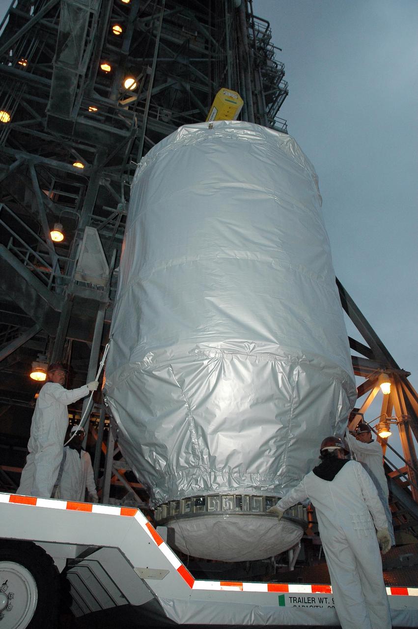 KENNEDY SPACE CENTER, FLA. --   On Launch Pad 17-B at Cape Canaveral Air Force Station, technicians stand by as the THEMIS spacecraft is lifted off its transporter.  The spacecraft will be lifted into the mobile service tower and, after encapsulation, mated with the third stage of the Delta II rocket.  THEMIS consists of five identical probes, the largest number of scientific satellites ever launched into orbit aboard a single rocket. The THEMIS mission is to investigate what causes auroras in the Earth's atmosphere to dramatically change from slowly shimmering waves of light to wildly shifting streaks of color. Discovering what causes auroras to change will provide scientists with important details on how the planet's magnetosphere works and the important Sun-Earth connection.  THEMIS is scheduled to launch aboard a Delta II rocket on Feb. 15 during a window extending from 6:08 to 6:27 p.m.  Photo credit: NASA/Amanda Diller