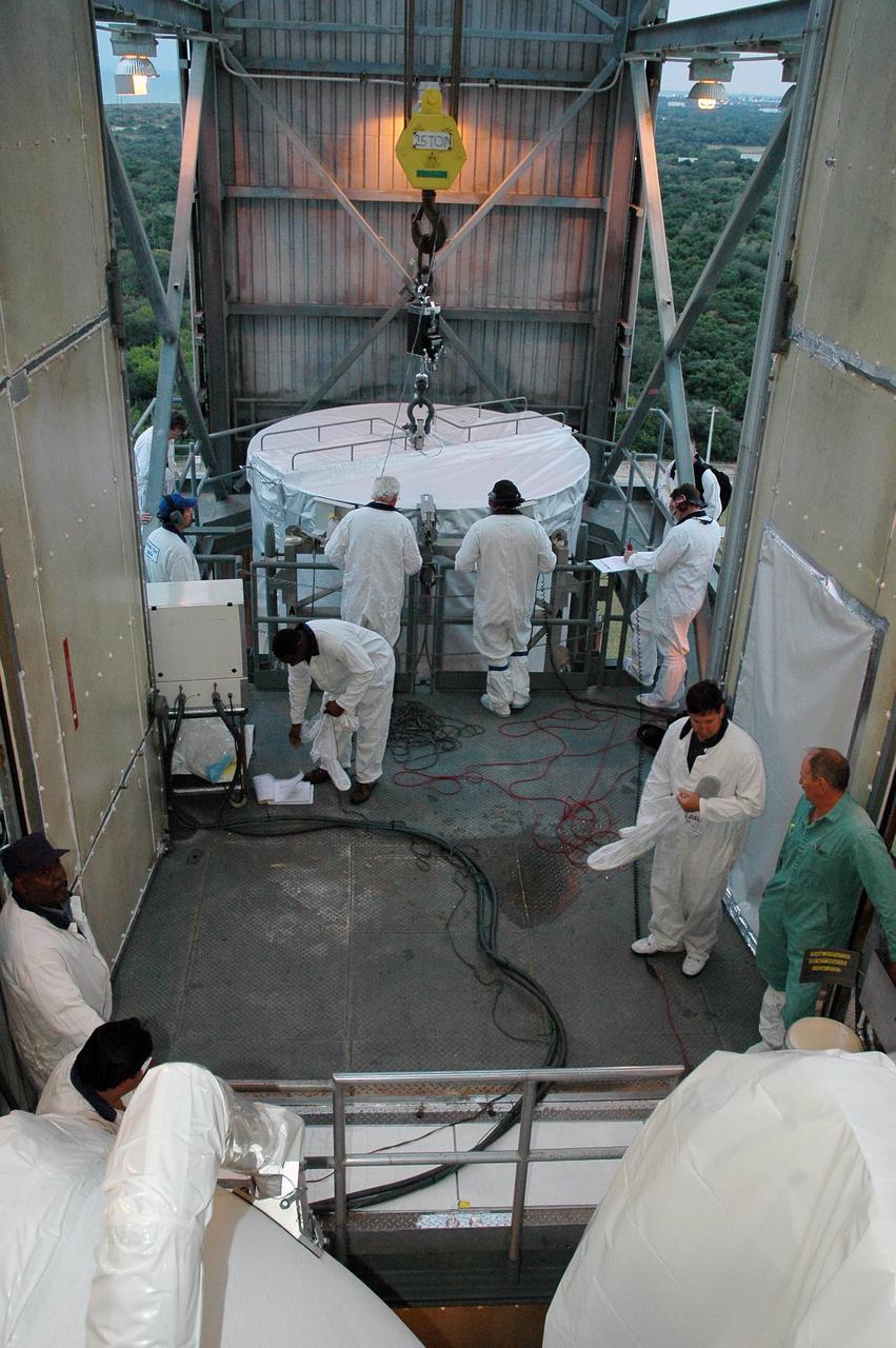 KENNEDY SPACE CENTER, FLA. --  In the upper level of the mobile service tower on Launch Pad 17-B at Cape Canaveral Air Force Station, workers wait for the THEMIS spacecraft (background) to be lifted and moved inside.  THEMIS will then be encapsulated and mated with the third stage of the Delta II rocket.  THEMIS consists of five identical probes, the largest number of scientific satellites ever launched into orbit aboard a single rocket. The THEMIS mission is to investigate what causes auroras in the Earth's atmosphere to dramatically change from slowly shimmering waves of light to wildly shifting streaks of color. Discovering what causes auroras to change will provide scientists with important details on how the planet's magnetosphere works and the important Sun-Earth connection.  THEMIS is scheduled to launch aboard a Delta II rocket on Feb. 15 during a window extending from 6:08 to 6:27 p.m.  Photo credit: NASA/Amanda Diller
