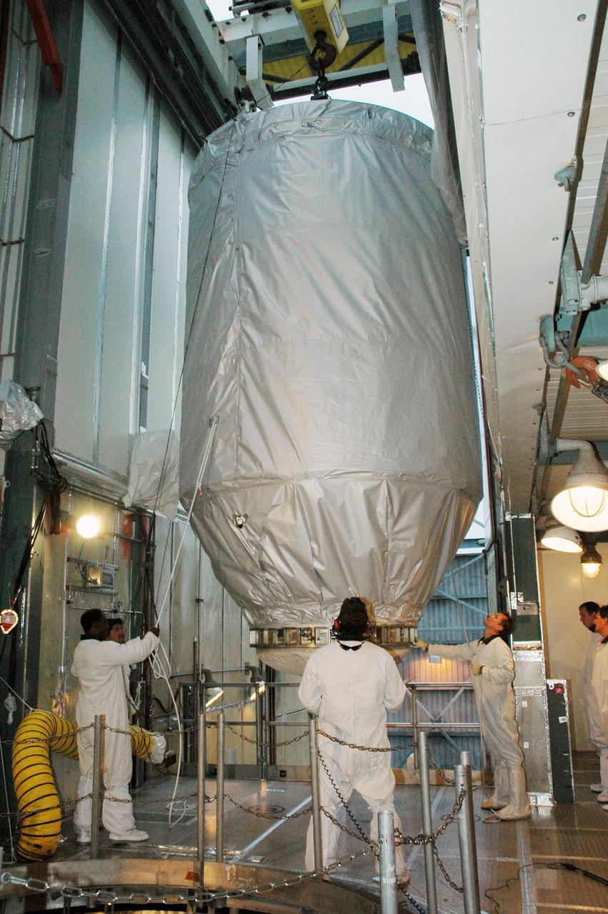KENNEDY SPACE CENTER, FLA. --  In the upper level of the mobile service tower on Launch Pad 17-B at Cape Canaveral Air Force Station, workers help maneuver the THEMIS spacecraft inside.  THEMIS will then be encapsulated and mated with the third stage of the Delta II rocket. THEMIS consists of five identical probes, the largest number of scientific satellites ever launched into orbit aboard a single rocket. The THEMIS mission is to investigate what causes auroras in the Earth's atmosphere to dramatically change from slowly shimmering waves of light to wildly shifting streaks of color. Discovering what causes auroras to change will provide scientists with important details on how the planet's magnetosphere works and the important Sun-Earth connection.  THEMIS is scheduled to launch aboard a Delta II rocket on Feb. 15 during a window extending from 6:08 to 6:27 p.m.  Photo credit: NASA/Amanda Diller