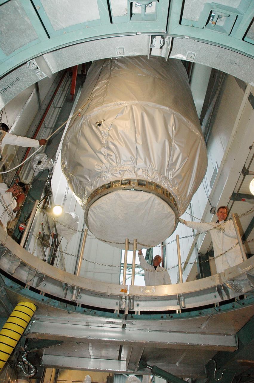 KENNEDY SPACE CENTER, FLA. --  In the upper level of the mobile service tower on Launch Pad 17-B at Cape Canaveral Air Force Station, workers help maneuver the THEMIS spacecraft into place.  They will next remove the protective cover before encapsulating and mating the spacecraft with the third stage of the Delta II rocket. THEMIS consists of five identical probes, the largest number of scientific satellites ever launched into orbit aboard a single rocket. The THEMIS mission is to investigate what causes auroras in the Earth's atmosphere to dramatically change from slowly shimmering waves of light to wildly shifting streaks of color. Discovering what causes auroras to change will provide scientists with important details on how the planet's magnetosphere works and the important Sun-Earth connection.  THEMIS is scheduled to launch aboard a Delta II rocket on Feb. 15 during a window extending from 6:08 to 6:27 p.m.  Photo credit: NASA/Amanda Diller