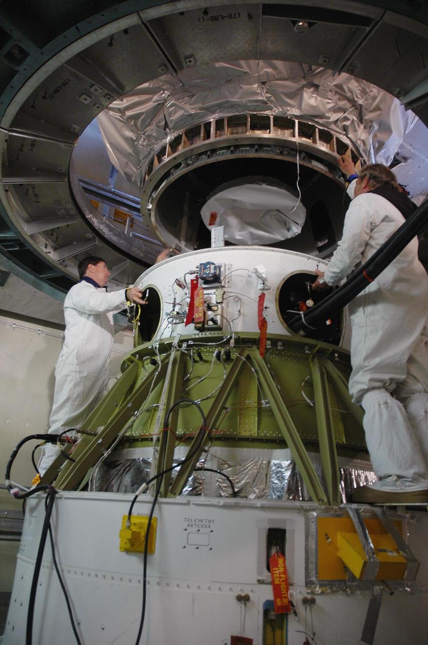 KENNEDY SPACE CENTER, FLA. --  Inside the mobile service tower on Launch Pad 17-B at Cape Canaveral Air Force Station, workers remove the protective cover surrounding the THEMIS spacecraft.  THEMIS consists of five identical probes, the largest number of scientific satellites ever launched into orbit aboard a single rocket. The THEMIS mission is to investigate what causes auroras in the Earth's atmosphere to dramatically change from slowly shimmering waves of light to wildly shifting streaks of color. Discovering what causes auroras to change will provide scientists with important details on how the planet's magnetosphere works and the important Sun-Earth connection.  THEMIS is scheduled to launch aboard a Delta II rocket on Feb. 15 during a window extending from 6:08 to 6:27 p.m.  Photo credit: NASA/Amanda Diller