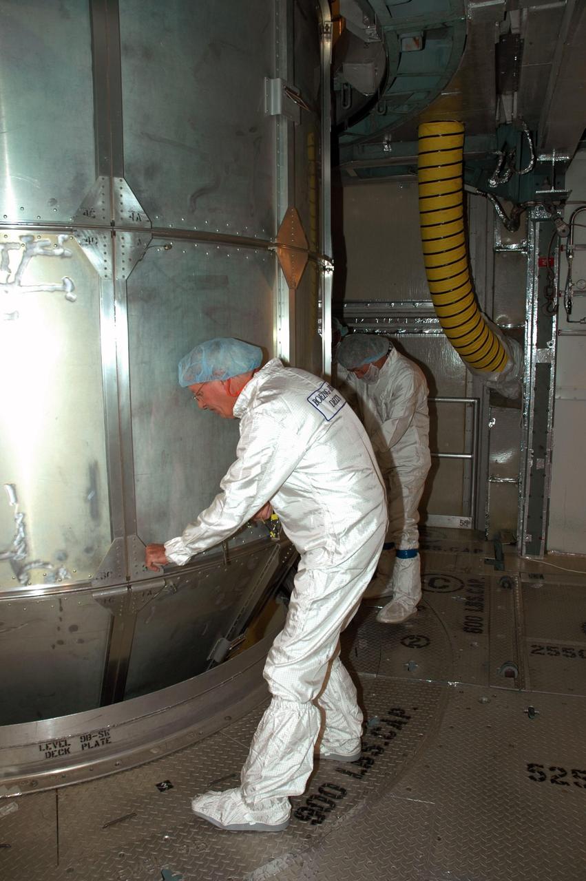 KENNEDY SPACE CENTER, FLA. --  Workers inside the mobile service tower on Launch Pad 17-B at Cape Canaveral Air Force Station prepare to remove the canister surrounding the THEMIS spacecraft.   THEMIS consists of five identical probes, the largest number of scientific satellites ever launched into orbit aboard a single rocket. The THEMIS mission is to investigate what causes auroras in the Earth's atmosphere to dramatically change from slowly shimmering waves of light to wildly shifting streaks of color. Discovering what causes auroras to change will provide scientists with important details on how the planet's magnetosphere works and the important Sun-Earth connection.  THEMIS is scheduled to launch aboard a Delta II rocket on Feb. 15 during a window extending from 6:08 to 6:27 p.m.  Photo credit: NASA/Amanda Diller