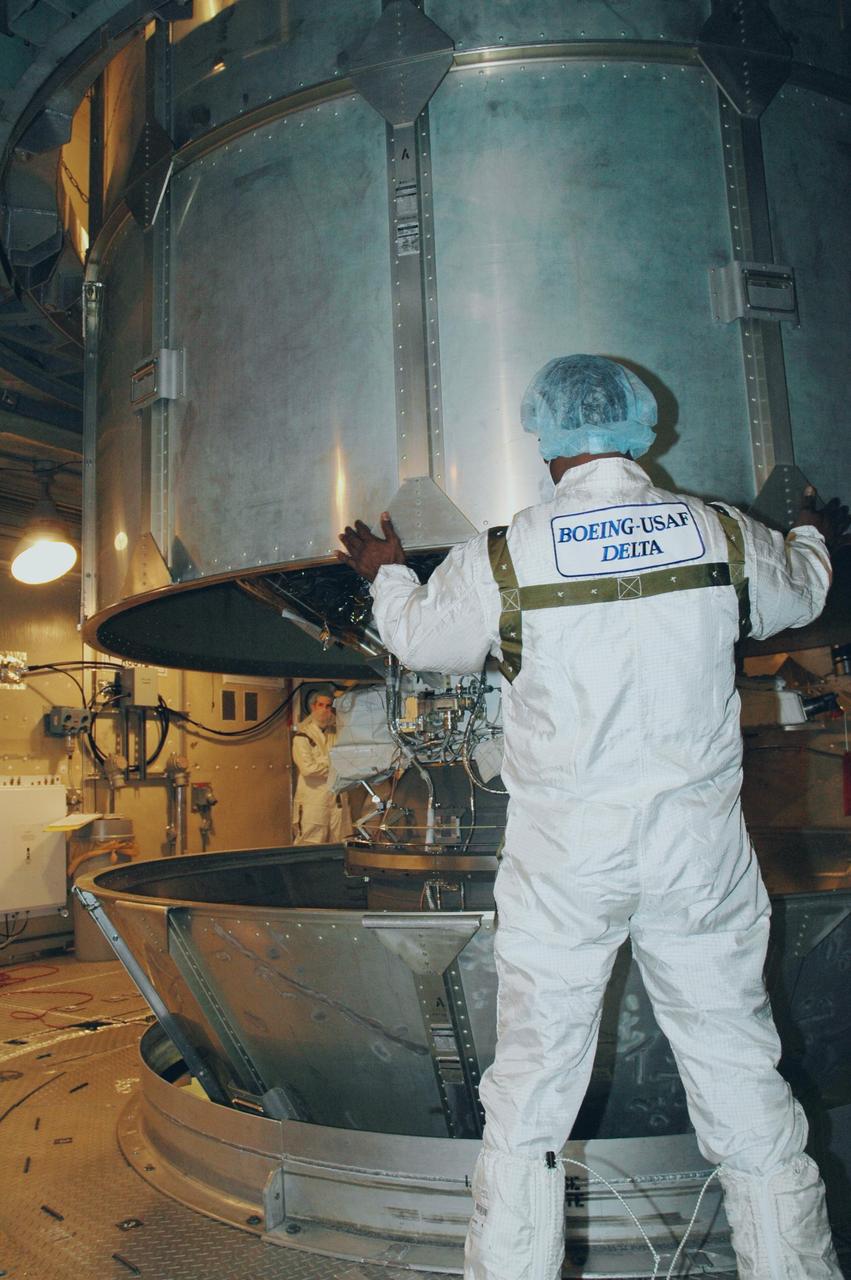 KENNEDY SPACE CENTER, FLA. -- Workers inside the mobile service tower on Launch Pad 17-B at Cape Canaveral Air Force Station maneuver the upper canister away from the THEMIS spacecraft.   THEMIS consists of five identical probes, the largest number of scientific satellites ever launched into orbit aboard a single rocket. The THEMIS mission is to investigate what causes auroras in the Earth's atmosphere to dramatically change from slowly shimmering waves of light to wildly shifting streaks of color. Discovering what causes auroras to change will provide scientists with important details on how the planet's magnetosphere works and the important Sun-Earth connection.  THEMIS is scheduled to launch aboard a Delta II rocket on Feb. 15 during a window extending from 6:08 to 6:27 p.m.  Photo credit: NASA/Amanda Diller