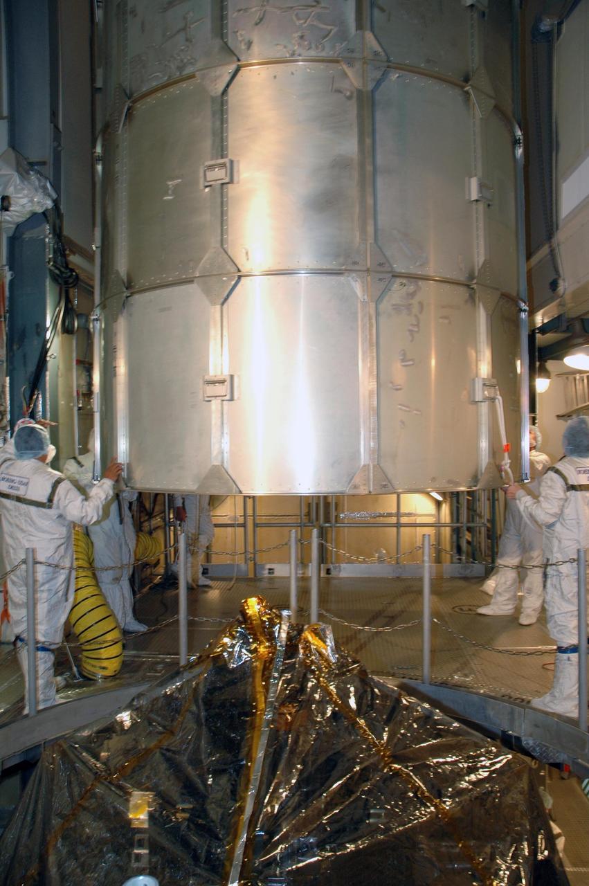 KENNEDY SPACE CENTER, FLA. --  Workers inside the mobile service tower on Launch Pad 17-B at Cape Canaveral Air Force Station help maneuver the upper canister away from the opening. The canister was removed from around the THEMIS spacecraft.  THEMIS consists of five identical probes, the largest number of scientific satellites ever launched into orbit aboard a single rocket. The THEMIS mission is to investigate what causes auroras in the Earth's atmosphere to dramatically change from slowly shimmering waves of light to wildly shifting streaks of color. Discovering what causes auroras to change will provide scientists with important details on how the planet's magnetosphere works and the important Sun-Earth connection.  THEMIS is scheduled to launch aboard a Delta II rocket on Feb. 15 during a window extending from 6:08 to 6:27 p.m.  Photo credit: NASA/Amanda Diller