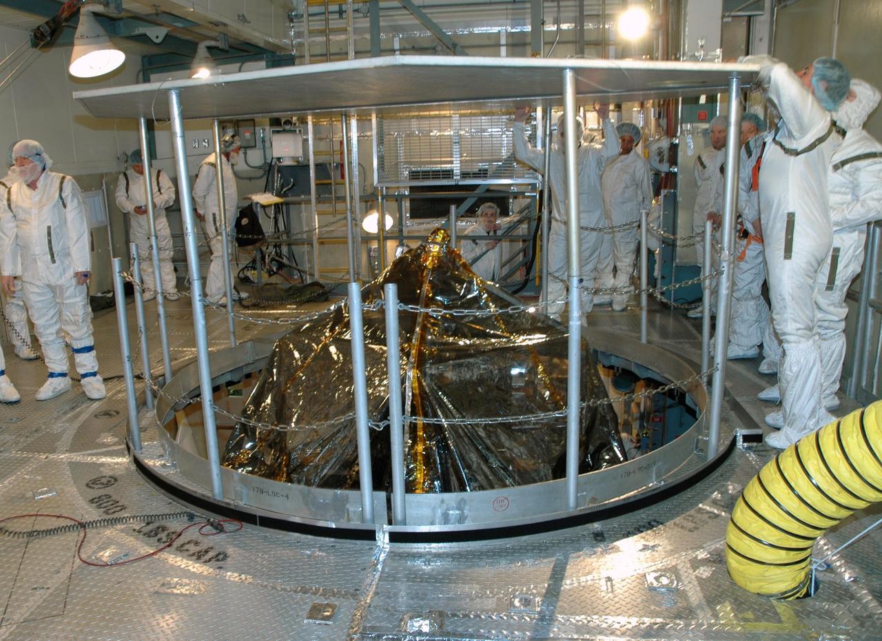 KENNEDY SPACE CENTER, FLA. --   Inside the mobile service tower on Launch Pad 17-B at Cape Canaveral Air Force Station, workers erect a protective screen above the THEMIS spacecraft to preserve a clean-room environment. THEMIS consists of five identical probes, the largest number of scientific satellites ever launched into orbit aboard a single rocket. The THEMIS mission is to investigate what causes auroras in the Earth's atmosphere to dramatically change from slowly shimmering waves of light to wildly shifting streaks of color. Discovering what causes auroras to change will provide scientists with important details on how the planet's magnetosphere works and the important Sun-Earth connection.  THEMIS is scheduled to launch aboard a Delta II rocket on Feb. 15 during a window extending from 6:08 to 6:27 p.m.  Photo credit: NASA/Amanda Diller