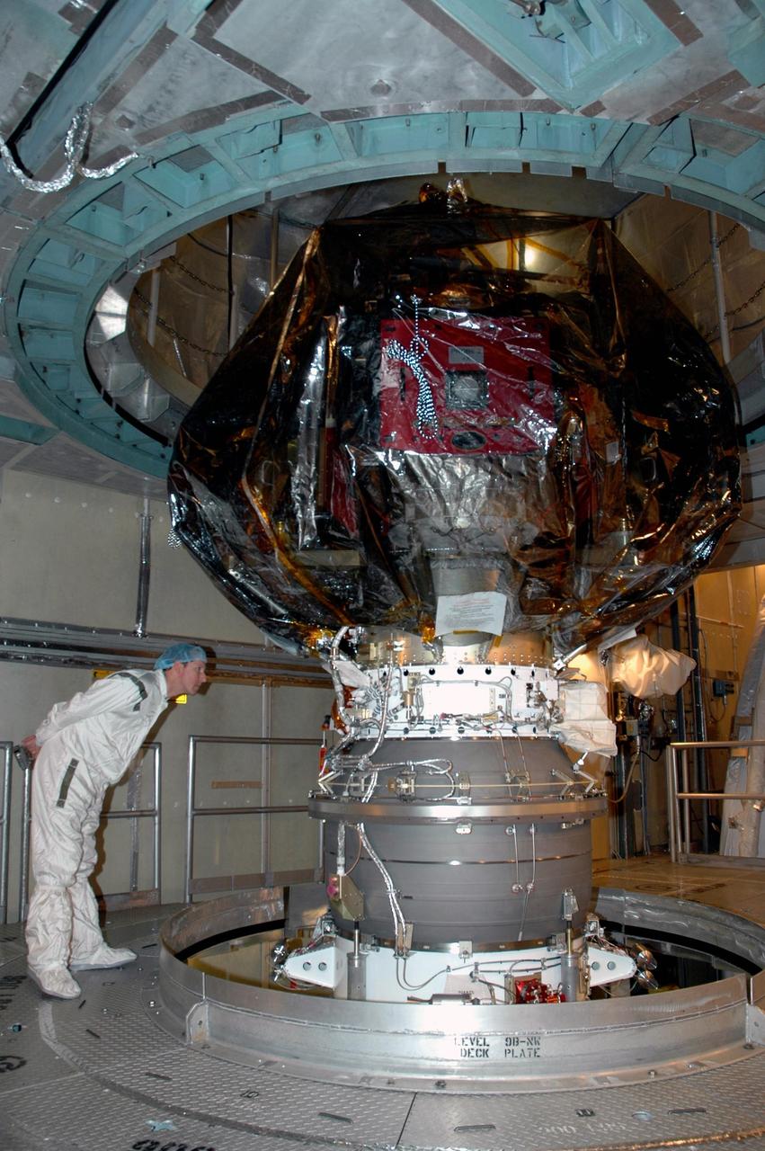 KENNEDY SPACE CENTER, FLA. --   A worker inside the mobile service tower on Launch Pad 17-B at Cape Canaveral Air Force Station examines the Delta II upper stage booster mated to the THEMIS spacecraft above.  THEMIS consists of five identical probes, the largest number of scientific satellites ever launched into orbit aboard a single rocket. The THEMIS mission is to investigate what causes auroras in the Earth's atmosphere to dramatically change from slowly shimmering waves of light to wildly shifting streaks of color. Discovering what causes auroras to change will provide scientists with important details on how the planet's magnetosphere works and the important Sun-Earth connection.  THEMIS is scheduled to launch aboard a Delta II rocket on Feb. 15 during a window extending from 6:08 to 6:27 p.m.  Photo credit: NASA/Amanda Diller