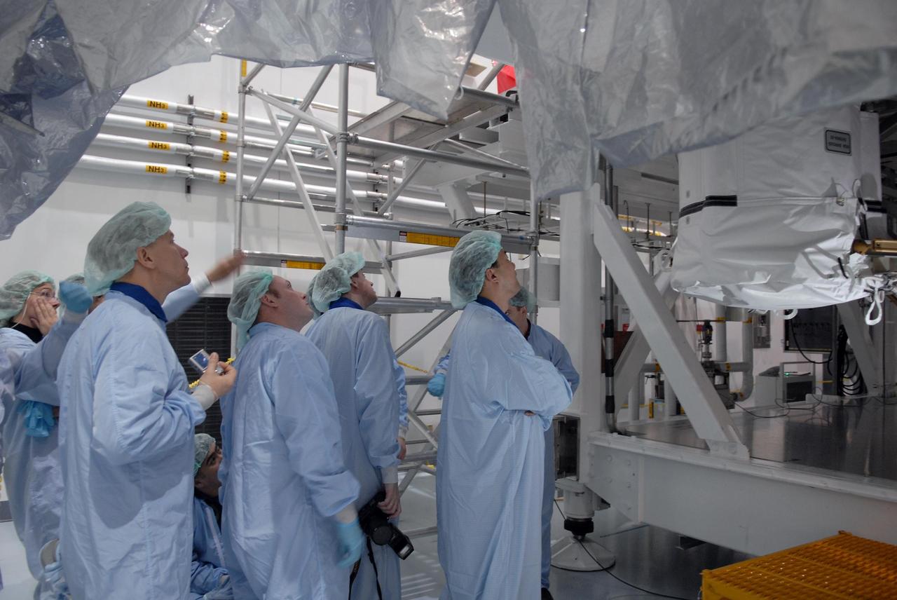 KENNEDY SPACE CENTER, FLA. --   In the Space Station Processing Facility, astronauts peer up into the stands holding the Node 2 module.  Visible from left are Sandra Magnuson, Tim Kopra, Michael Fincke, Frank DeWinne and Soichi Noguchi.  They and other astronauts are familiarizing themselves with the various elements to be installed on the International Space Station on future spaceflights.  With construction of the Space Station the primary focus of future shuttle missions, astronaut crews will be working with one or more of the elements and hardware already being processed in the SSPF.  Photo credit: NASA/Kim Shiflett