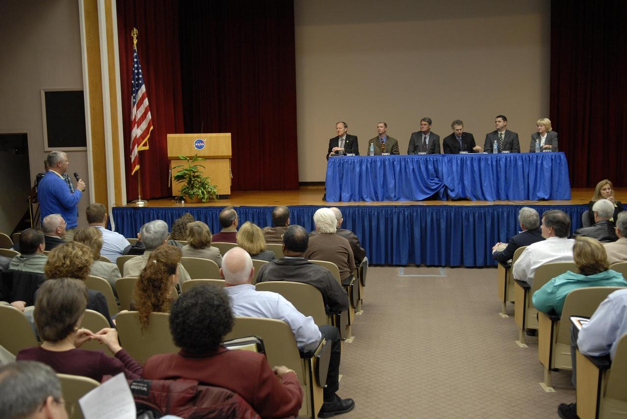 KENNEDY SPACE CENTER, FLA. --  During an all-hands meeting led by Center Director Bill Parsons (center left at the table), an employee asks for more information.  Topics discussed included the year ahead at KSC.  At the table on stage (from left) are Steve Francois, manager of Launch Services Program; Pepper Phillips, deputy director of the Constellation Program office; Parsons; Russ Romanella, director of the ISS & Spacecraft Processing Directorate; Jeff Angermeier, chief of the Project Control office in the Launch Vehicle Processing Directorate; and Shannon Bartell, director of NASA Safety and Mission Assurance.  Photo credit: NASA/Kim Shiflett