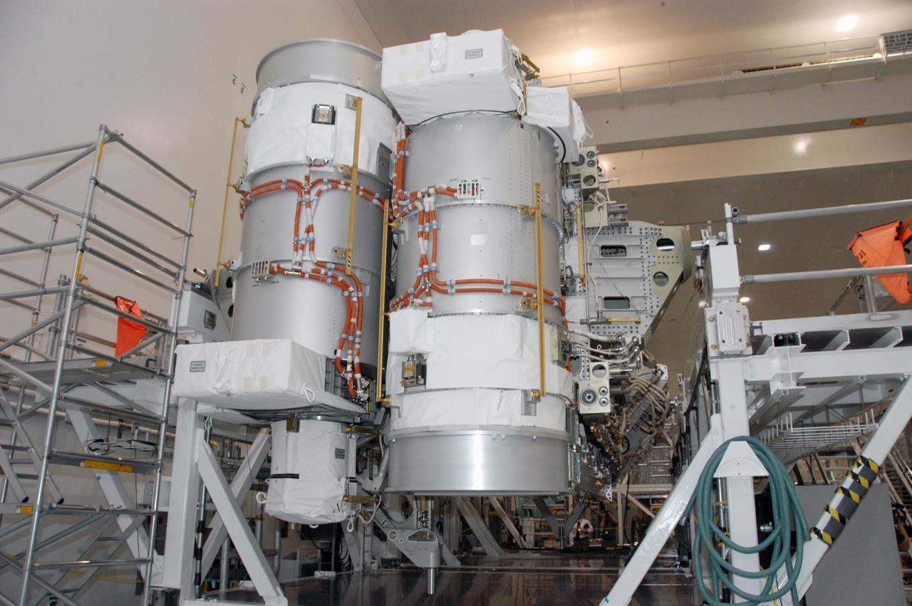 KENNEDY SPACE CENTER, FLA. --    In the Space Station Processing Facility, the S3/S4 integrated truss segment is on display for the media. The starboard 3/4 truss segment will launch aboard Space Shuttle Atlantis on mission STS-117, targeted for March 15.  The element will be added to the 11-segment integrated truss structure, the station's backbone. The integrated truss structure eventually will span more than 300 feet. The S3/S4 truss has two large solar arrays and will provide one-fourth of the total power generation for the completed station.  Photo credit: NASA/George Shelton