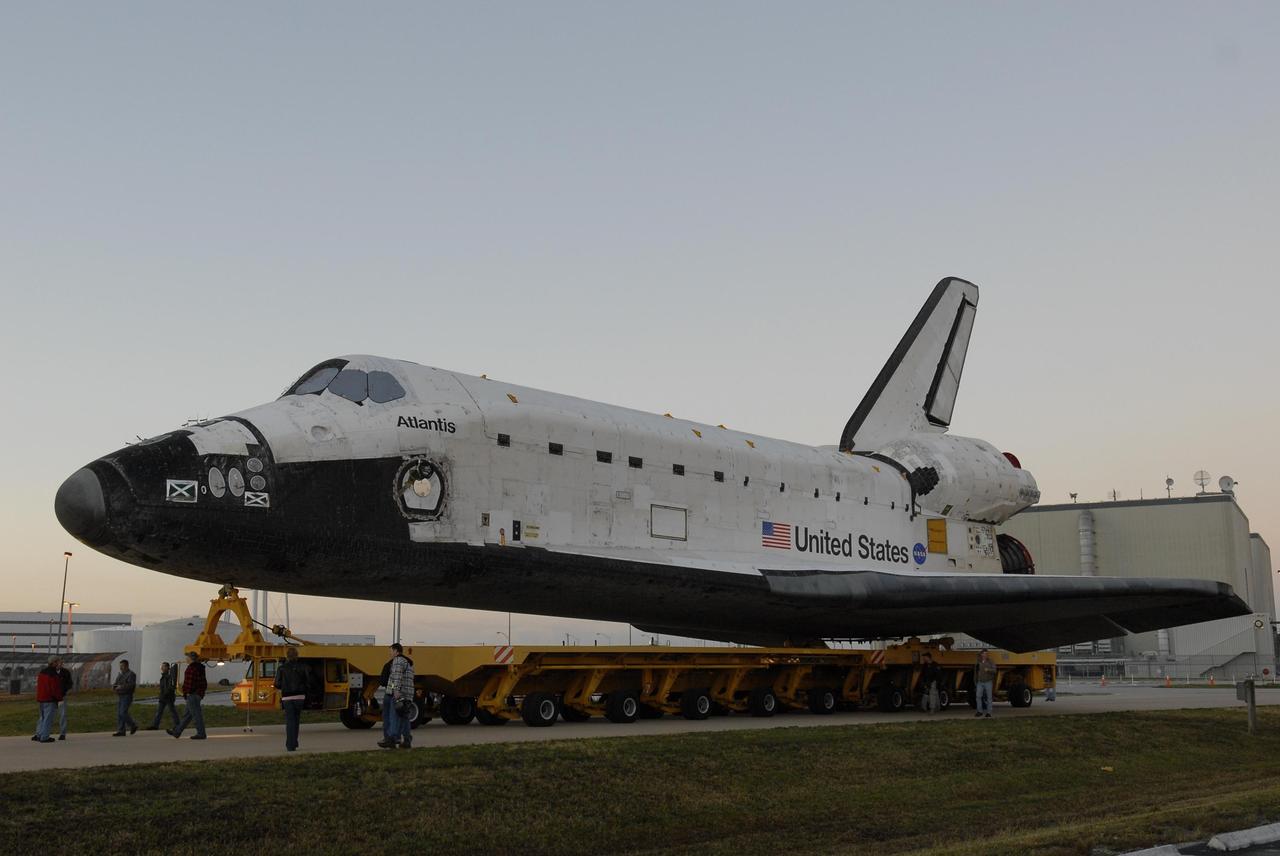 KENNEDY SPACE CENTER, FLA. --   The orbiter Atlantis, on top of its transporter, heads for the Vehicle Assembly Building after leaving the Orbiter Processing Facility.  First motion out of OPF was at 6:19 a.m. EST.  Once in the VAB, Atlantis will be lifted into high bay 1 and mated with the external tank and solid rocket boosters already in place on the mobile launcher platform. The rollover signals the start of the journey to the launch pad for liftoff on mission STS-117 targeted for March 15.  The mission is the 21st to the International Space Station and will deliver the S3/S4 starboard truss segments.  Photo credit: NASA/Kim Shiflett