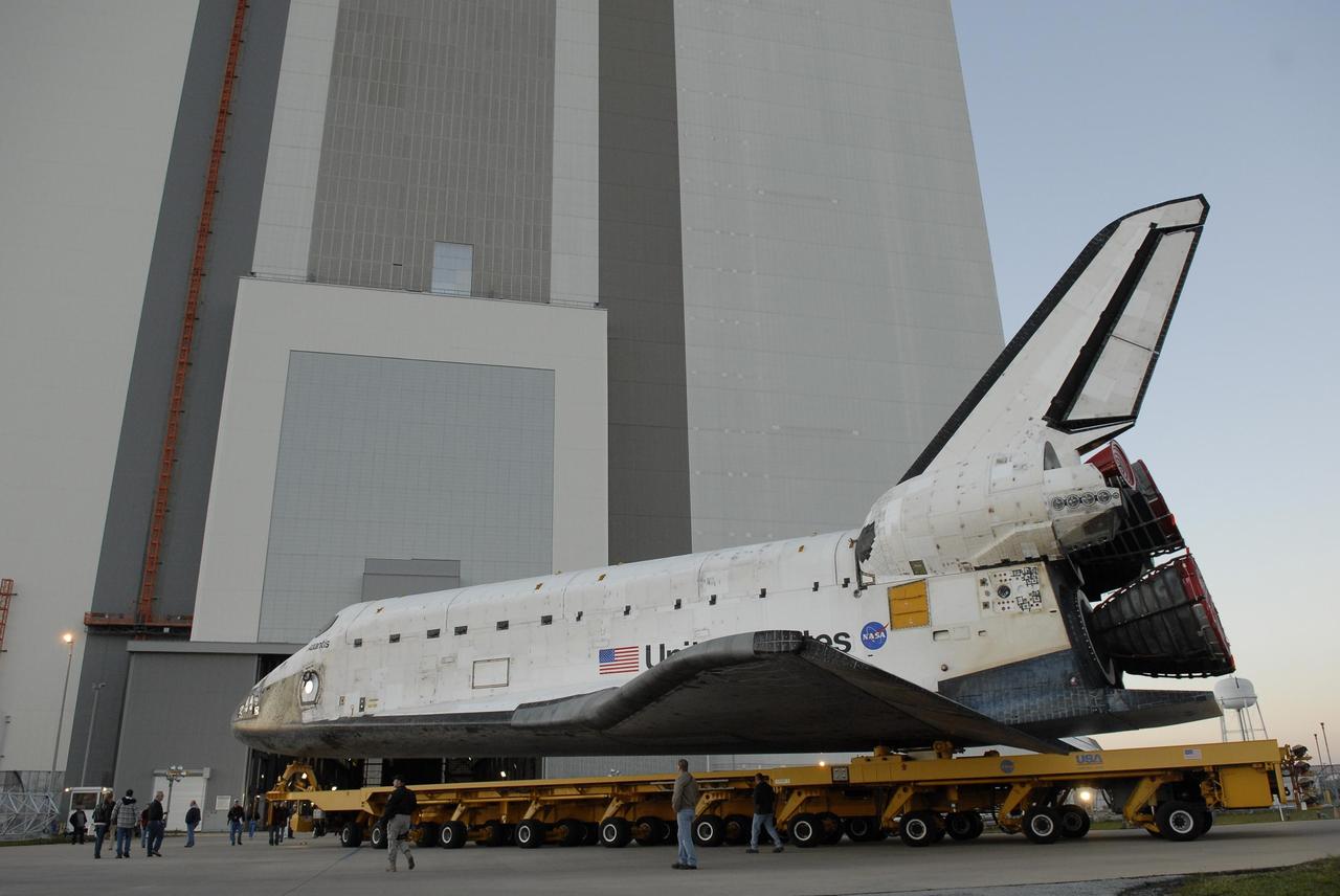 KENNEDY SPACE CENTER, FLA. --    The orbiter Atlantis, on top of its transporter, turns toward the Vehicle Assembly Building after leaving the Orbiter Processing Facility.  First motion out of OPF was at 6:19 a.m. EST. Once in the VAB, Atlantis will be lifted into high bay 1 and mated with the external tank and solid rocket boosters already in place on the mobile launcher platform. The rollover signals the start of the journey to the launch pad for liftoff on mission STS-117 targeted for March 15.  The mission is the 21st to the International Space Station and will deliver the S3/S4 starboard truss segments.  Photo credit: NASA/Kim Shiflett