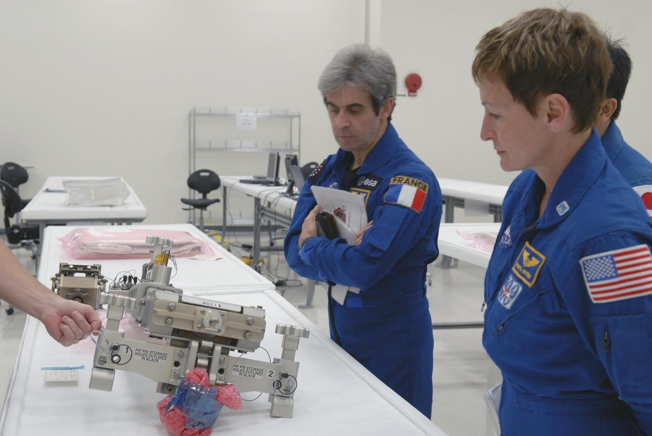 KENNEDY SPACE CENTER, FLA. -- In the Space Station Processing Facility, astronauts familiarize themselves with hardware and modules to be flown on upcoming shuttle flights. Seen here are Leopold Eyharts and Peggy Whitson. With construction of the Space Station the primary focus of future shuttle missions, astronaut crews will be working with one or more of the elements and hardware already being processed in the SSPF. Photo credit: NASA/Kim Shiflett