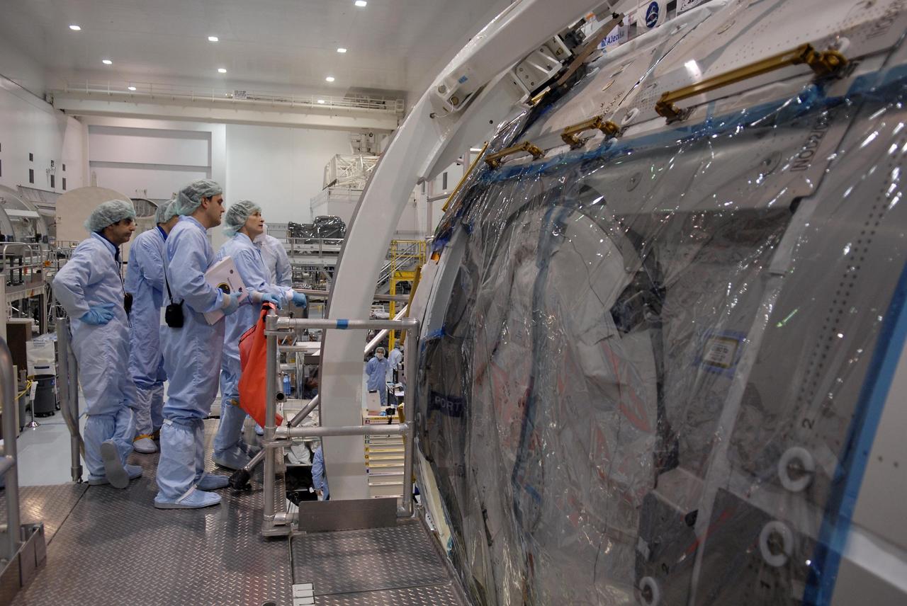 KENNEDY SPACE CENTER, FLA. -- In the Space Station Processing Facility, astronauts look at one end of a module being processed for the International Space Station. Accompanied by technicians, at far left is Leopold Eyharts; at far right is Peggy Whitson. With construction of the Space Station the primary focus of future shuttle missions, astronaut crews will be working with one or more of the elements and hardware already being processed in the SSPF. Photo credit: NASA/Kim Shiflett
