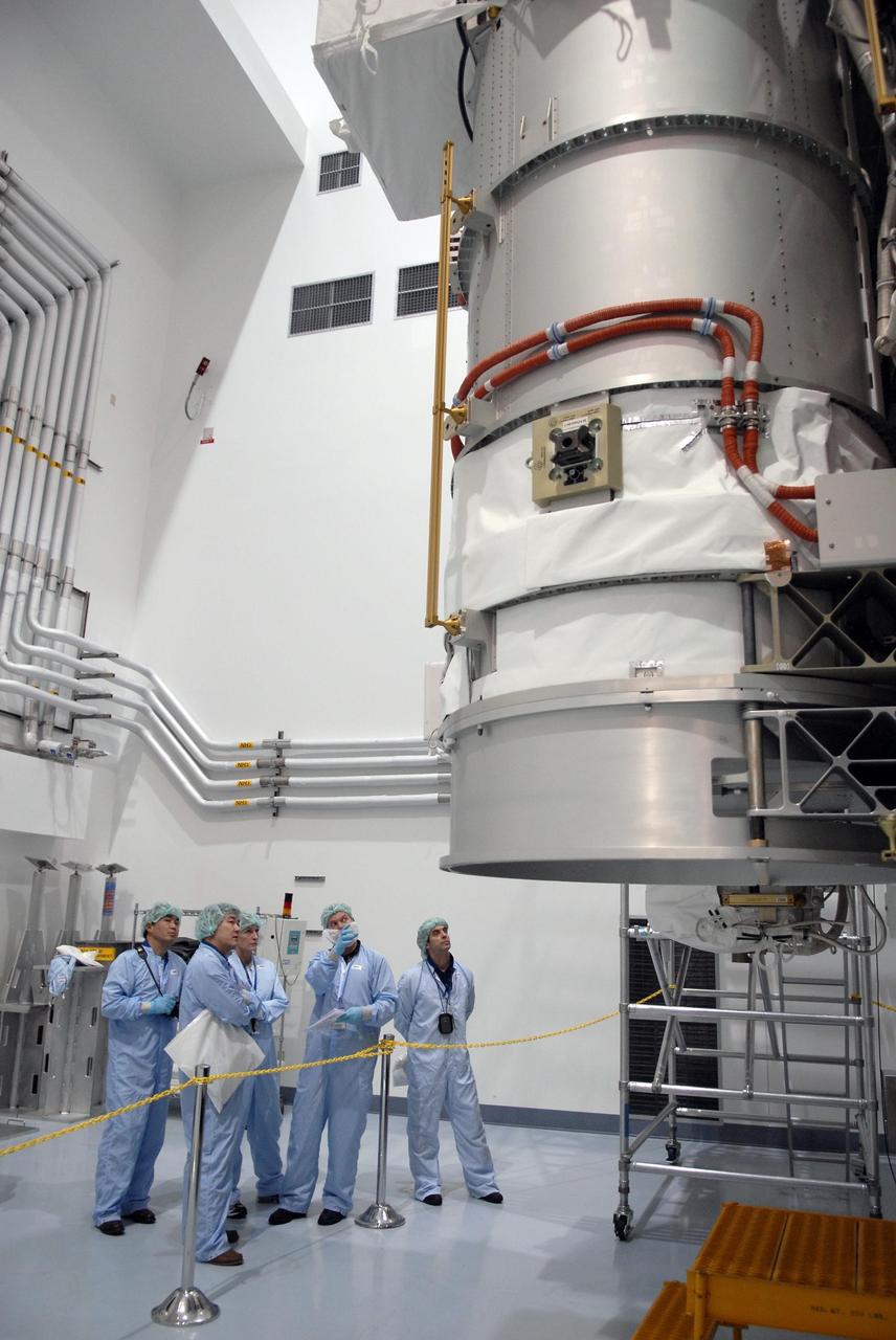 KENNEDY SPACE CENTER, FLA. -- From the floor of the Space Station Processing Facility, astronauts get a look at the S6 integrated truss and solar arrays, scheduled to fly on STS-119 in 2008.  On the left are Koichi Wakata, Dan Tani and Peggy Whitson.  With construction of the Space Station the primary focus of future shuttle missions, astronaut crews will be working with one or more of the elements and hardware already being processed in the SSPF.  Photo credit: NASA/Kim Shiflett