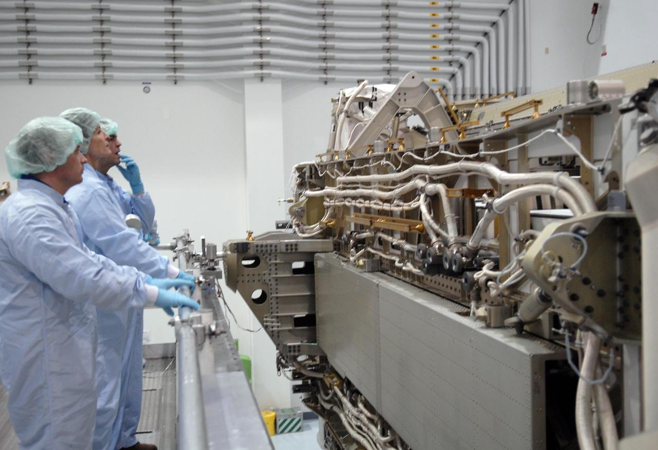 KENNEDY SPACE CENTER, FLA. -- In the Space Station Processing Facility, astronauts Garrett Reisman, Peggy Whitson and Leopold Eyharts look at one of the modules being processed there. The hardware will be flown on an upcoming shuttle flight. With construction of the Space Station the primary focus of future shuttle missions, astronaut crews will be working with one or more of the elements and hardware already being processed in the SSPF. Photo credit: NASA/Kim Shiflett