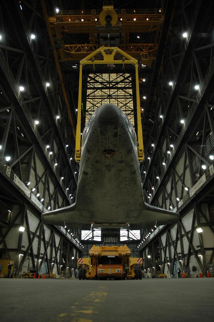 KENNEDY SPACE CENTER, FLA. --  In  In the transfer aisle of the Vehicle Assembly Building, the orbiter Atlantis is suspended by a sling.  The orbiter will be raised to vertical and lifted up into high bay 1.   Then it will be lowered onto the mobile launcher platform where the external tank and solid rocket boosters are already stacked.  Space Shuttle Atlantis is targeted to roll out to Launch Pad 39A on February 14 for mission STS-117. The mission is No. 21 to the International Space Station and construction flight 13A. Photo credit: NASA/Amanda Diller