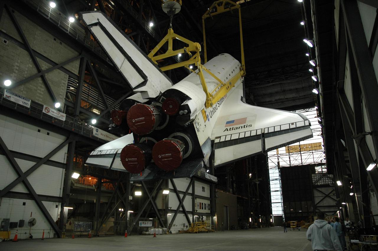 KENNEDY SPACE CENTER, FLA. -- In the transfer aisle of the Vehicle Assembly Building, the orbiter Atlantis is being raised to a vertical position. Then it will be lifted up into high bay 1 and lowered onto the mobile launcher platform where the external tank and solid rocket boosters are already stacked. Space Shuttle Atlantis is targeted to roll out to Launch Pad 39A on February 14 for mission STS-117. The mission is No. 21 to the International Space Station and construction flight 13A. Photo credit: NASA/Amanda Diller
