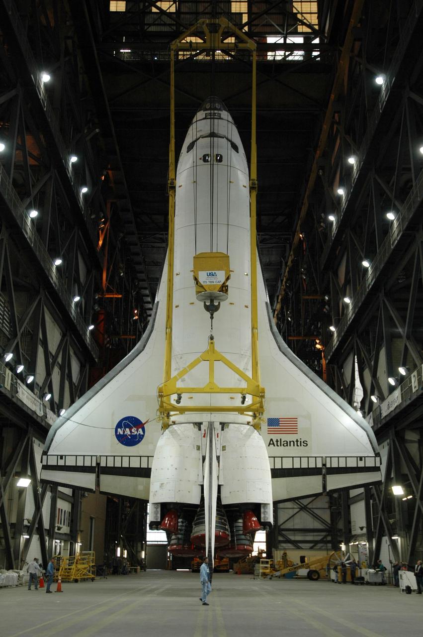 KENNEDY SPACE CENTER, FLA. -- The orbiter Atlantis is suspended vertically above the transfer aisle of the Vehicle Assembly Building. It will be lifted up into high bay 1 and lowered onto the mobile launcher platform where the external tank and solid rocket boosters are already stacked. Space Shuttle Atlantis is targeted to roll out to Launch Pad 39A on February 14 for mission STS-117. The mission is No. 21 to the International Space Station and construction flight 13A. Photo credit: NASA/Amanda Diller