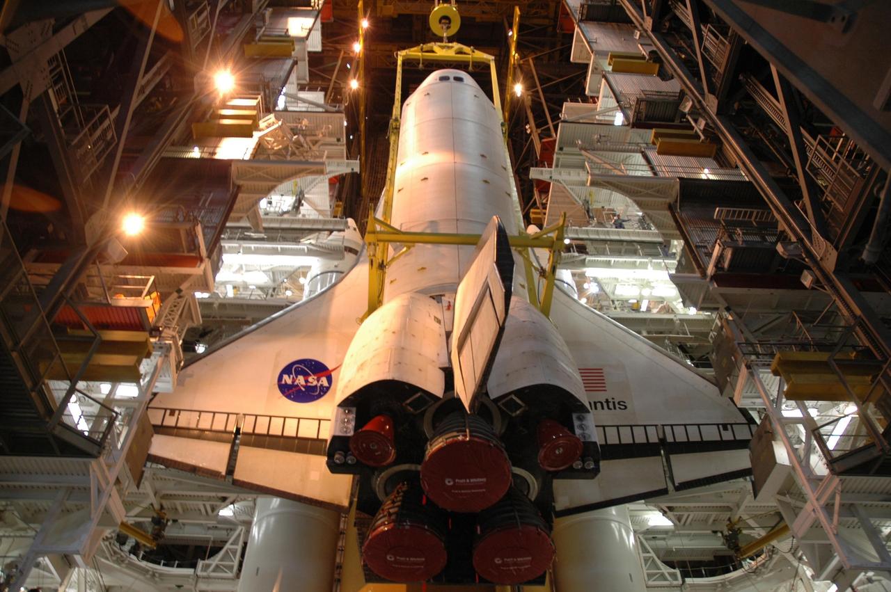 KENNEDY SPACE CENTER, FLA. --   The overhead sling lowers the orbiter Atlantis in front of the external tank and solid rocket boosters stacked on the mobile launcher platform (MLP) below.  Atlantis will be mated to the MLP as well.  Space Shuttle Atlantis is targeted to roll out to Launch Pad 39A on February 14 for mission STS-117. The mission is No. 21 to the International Space Station and construction flight 13A. Photo credit: NASA/Amanda Diller