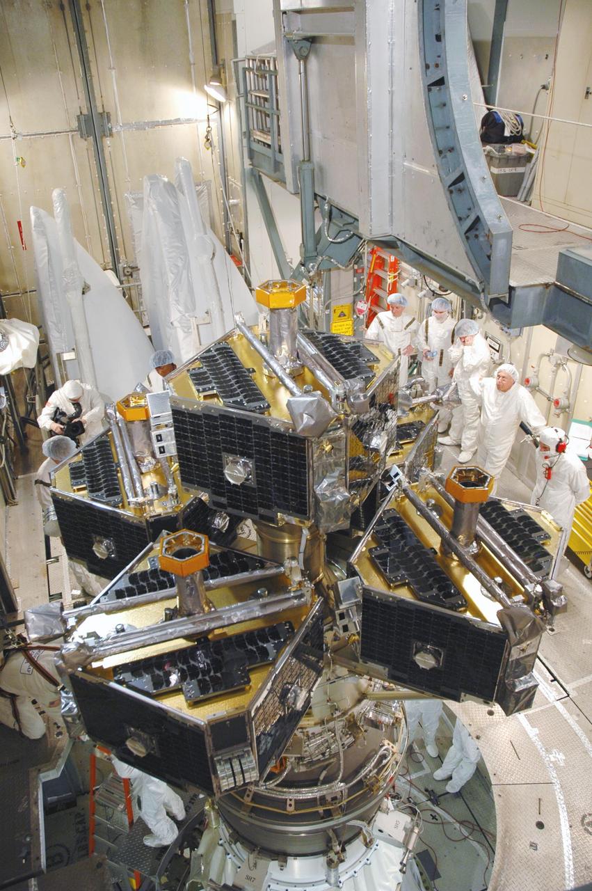 KENNEDY SPACE CENTER, FLA. --  In the mobile service tower on Pad 17-B at Cape Canaveral Air Force Station, workers prepare to install the fairing, seen in the background, around the THEMIS spacecraft.  The fairing is a molded structure that fits flush with the outside surface of the Delta II upper stage booster and forms an aerodynamically smooth nose cone, protecting the spacecraft during launch and ascent. THEMIS is an acronym for Time History of Events and Macroscale Interactions during Substorms.  THEMIS consists of five identical probes that will track violent, colorful eruptions near the North Pole.  This will be the largest number of scientific satellites NASA ever launched into orbit aboard a single rocket.  The THEMIS mission aims to unravel the tantalizing mystery behind auroral substorms, an avalanche of magnetic energy powered by the solar wind that intensifies the northern and southern lights.  The mission will investigate what causes auroras in the Earth’s atmosphere to dramatically change from slowly shimmering waves of light to wildly shifting streaks of bright color.  Launch of THEMIS is scheduled for Feb. 15 aboard a Delta II rocket, with the launch service being conducted by the United Launch Alliance.  Photo credit: NASA/Jim Grossmann