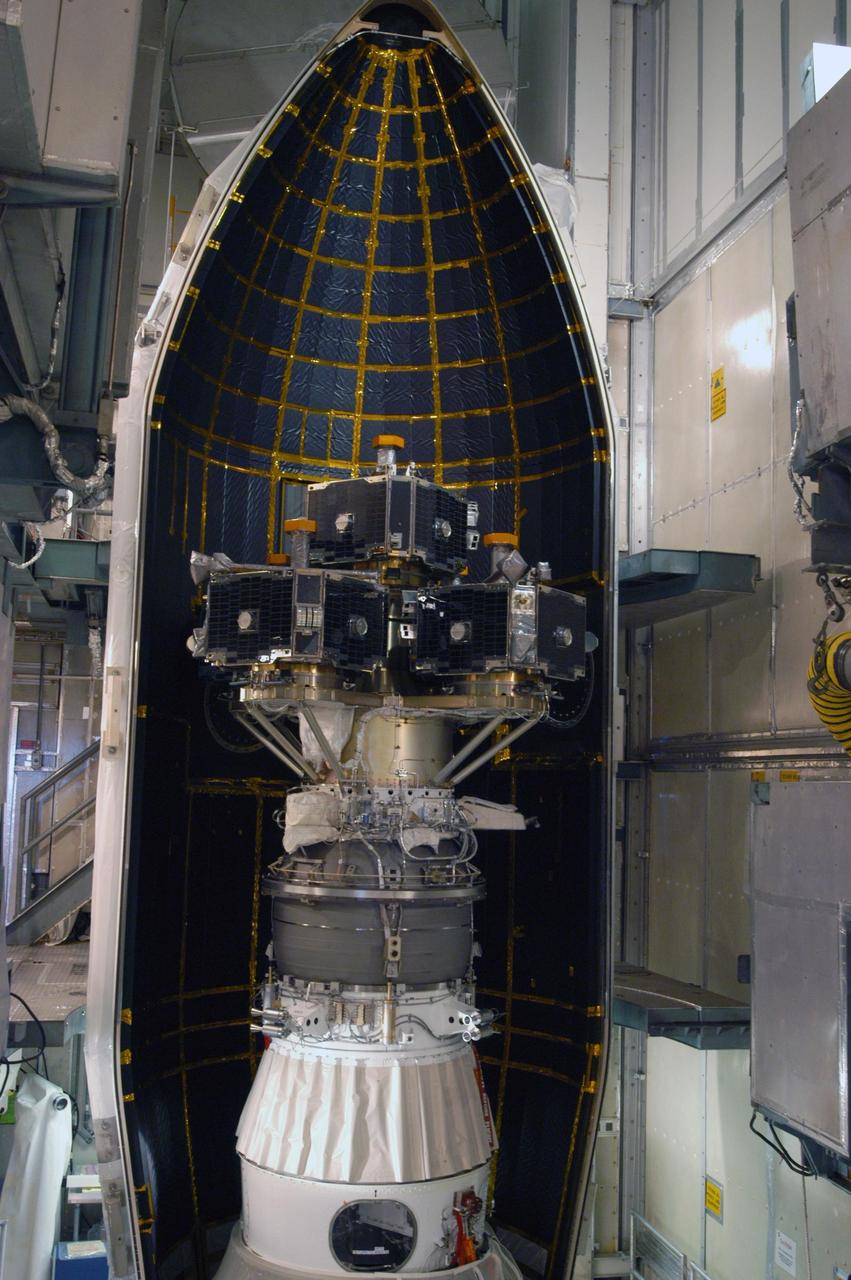 KENNEDY SPACE CENTER, FLA. --  In the mobile service tower on Pad 17-B at Cape Canaveral Air Force Station, the first half of the fairing is moved into place around the THEMIS spacecraft.  The fairing is a molded structure that fits flush with the outside surface of the Delta II upper stage booster and forms an aerodynamically smooth nose cone, protecting the spacecraft during launch and ascent.  THEMIS is an acronym for Time History of Events and Macroscale Interactions during Substorms.  THEMIS consists of five identical probes that will track violent, colorful eruptions near the North Pole.  This will be the largest number of scientific satellites NASA ever launched into orbit aboard a single rocket.  The THEMIS mission aims to unravel the tantalizing mystery behind auroral substorms, an avalanche of magnetic energy powered by the solar wind that intensifies the northern and southern lights.  The mission will investigate what causes auroras in the Earth’s atmosphere to dramatically change from slowly shimmering waves of light to wildly shifting streaks of bright color.  Launch of THEMIS is scheduled for Feb. 15 aboard a Delta II rocket, with the launch service being conducted by the United Launch Alliance.  Photo credit: NASA/George Shelton