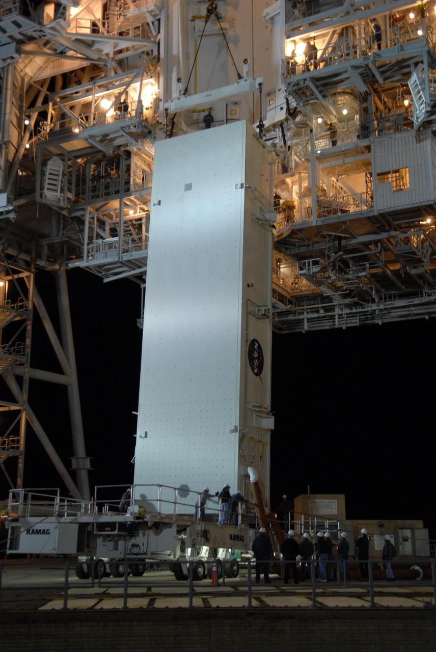 KENNEDY SPACE CENTER, FLA. --  The payload canister on its transporter sits beneath the payload changeout room on the rotating service structure (RSS) on Launch Pad 39A.  The canister contains the S3/S4 integrated truss for mission STS-117 to the International Space Station aboard Space Shuttle Atlantis. Once inside the PCR, the S3/S4 arrays will be transferred into Space Shuttle Atlantis' payload bay after the vehicle has rolled out to the pad.  The changeout room is the enclosed, environmentally controlled portion of the RSS that supports cargo delivery to the pad and subsequent vertical installation into the orbiter payload bay. The Atlantis crew will install the new truss segment, retract a set of solar arrays and unfold a new set on the starboard side of the station. Launch is targeted for March 15.  Photo credit: NASA/Kim Shiflett