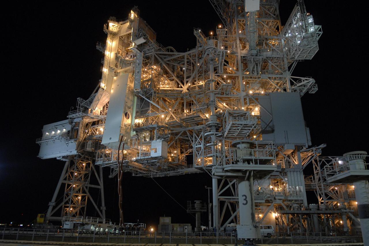 KENNEDY SPACE CENTER, FLA. --  With umbilical lines still attached, the payload canister is lifted up to the payload changeout room on the rotating service structure (RSS) on Launch Pad 39A The canister contains the S3/S4 integrated truss for mission STS-117 to the International Space Station aboard Space Shuttle Atlantis. Once inside the PCR, the S3/S4 arrays will be transferred into Space Shuttle Atlantis' payload bay after the vehicle has rolled out to the pad.  The changeout room is the enclosed, environmentally controlled portion of the RSS that supports cargo delivery to the pad and subsequent vertical installation into the orbiter payload bay. The Atlantis crew will install the new truss segment, retract a set of solar arrays and unfold a new set on the starboard side of the station. Launch is targeted for March 15.  Photo credit: NASA/Kim Shiflett